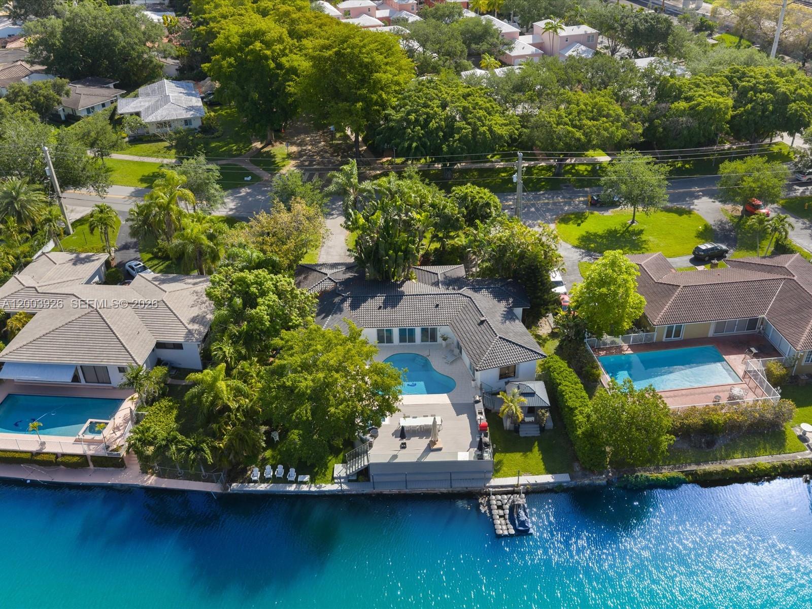 Discover a rare opportunity to own a prime waterfront property in the prestigious city of Coral Gables. This exceptional 4-bedroom, 4-bathroom home sits on a sought-after seawater canal, offering direct water access—an increasingly hard-to-find feature in the area.
Boating enthusiasts will appreciate the private dock and dedicated jet ski platform, perfect for enjoying South Florida’s waterfront lifestyle right from your backyard.
The property was thoughtfully renovated in 2024, featuring a new modern kitchen and four fully renovated bathrooms equipped with smart technology, along with tasteful aesthetic enhancements throughout the home. Most of the windows are impact, providing added storm protection and energy efficiency. A newer septic tank adds additional peace of mind.
Step outside to a spacious backyard oasis with lush landscaping and mature trees, including a fruitful mango tree, deck, pool and spa creating a serene and private outdoor retreat ideal for relaxing or entertaining. Nice pool and Jacuzzi.
This is a unique chance to own a move-in-ready waterfront home in one of South Florida’s most desirable communities.