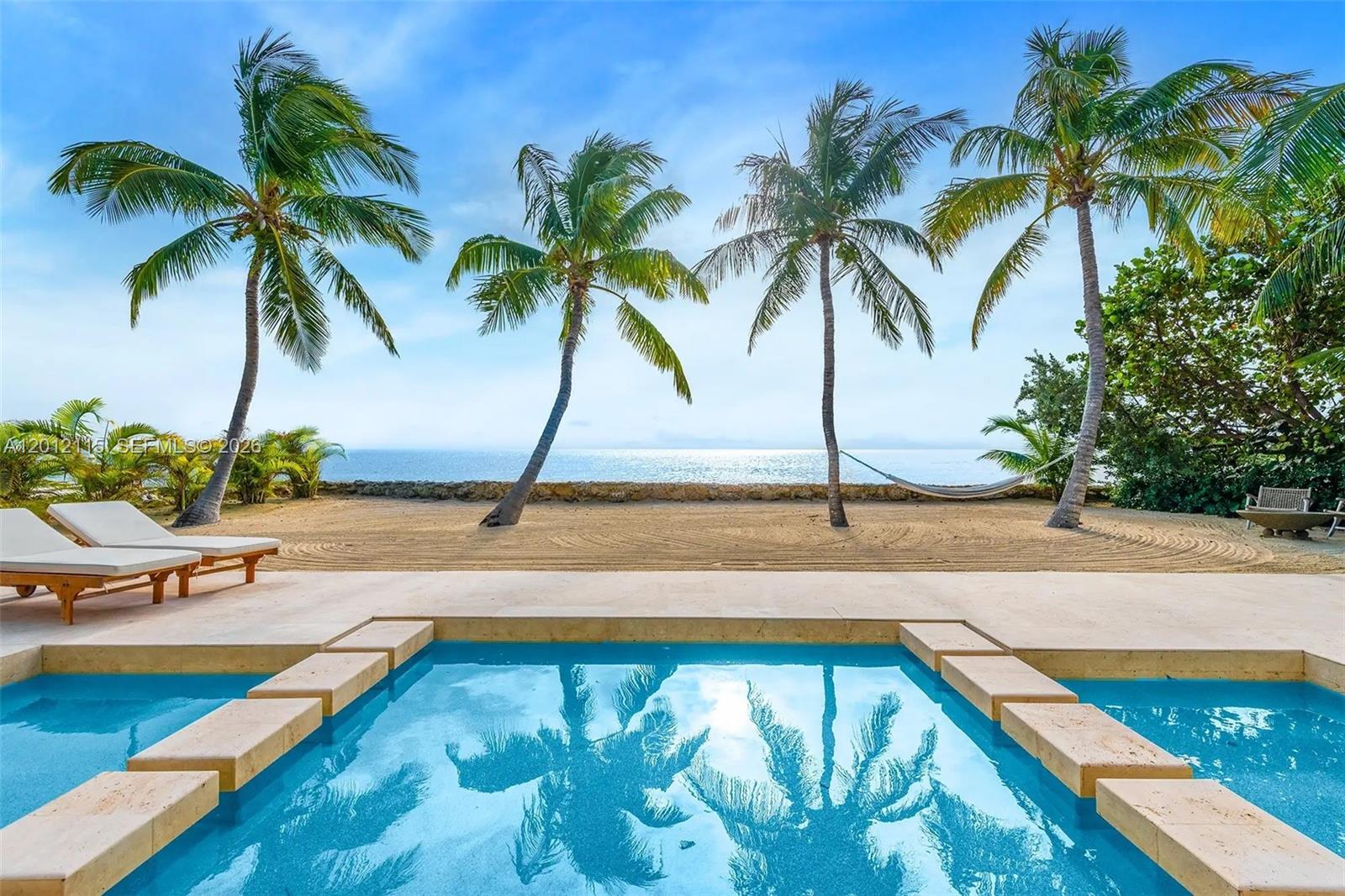 Best opportunity with best view in Florida Keys! Experience coastal luxury at The Oasis, a striking oceanfront sanctuary with 86 feet of direct Atlantic frontage nestled within the most exclusive area of Key Largo. Designed to blur the lines between indoors and out, this 3-bedroom/3-bathroom stunning residence spans approximately 2,500 square feet and features floor-to-ceiling windows that flood interiors with natural light, while an open-concept layout connects elegant living spaces to expansive terraces overlooking the ocean. 
Resort style amenities are highlighted by a 75-foot infinity-edge pool stretching toward the horizon, creating a breathtaking centerpiece for relaxation and entertaining. The property’s lush tropical landscaping, covered patio, and outdoor gas-powered kitchen make it ideal for hosting gatherings or enjoying breathtaking panoramic ocean views and quiet moments by the sea. Built with solid concrete construction, impact glass, and a metal roof, the home offers lasting peace of mind in a coastal environment. Perfectly positioned in one of Key Largo’s most desirable enclaves, and minutes from fine dining, marinas, and boutique shopping, The Oasis delivers an unmatched combination of style, serenity, and elegant oceanfront living. Conceptual architectural expansion plans are available for an additional 4-bedrooms/2-bathrooms along with documentation for the addition of a 150 ft. private dock. See due diligence for more information.