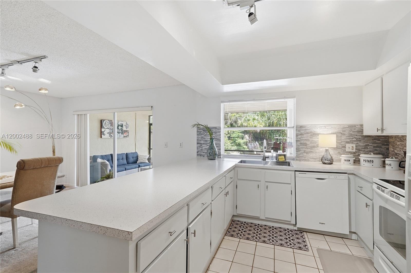 Huge 3 bedroom, 3 bathroom townhouse offering a bright, open layout and incredible potential to create your dream home. This light-filled unit features a welcoming front entrance, a formal dining area, and a unique sunken family room that is perfect for relaxing or entertaining. A full bathroom on the first floor adds flexibility for guests or multi-generational living. The oversized kitchen offers abundant counter space along with two pantry closets, ideal for storage and functionality. Upstairs, the expansive primary suite includes a private sitting area and access to a large balcony, creating a perfect retreat. Laundry is conveniently located on the second floor. Enjoy a peaceful and private backyard with a large screened-in patio and lanai that's ideal for outdoor living year-round. The home also features an updated electrical panel and a new roof currently being installed. Maintenance includes water, landscaping, and exterior building insurance. The 40-year inspection has been completed. Conveniently located near schools, shopping, and major roadways, offering easy access for daily living. A fantastic opportunity for a growing family.