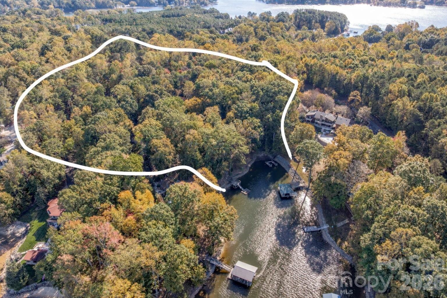 Positioned within the private enclave of Fern Hill on Lake Norman, this to-be-built 4,640-square-foot waterfront residence represents a rare opportunity to create an architecturally significant estate on an extraordinary setting. Spanning a rare 8 waterfront acres, the property offers a remarkable sense of arrival, where mature woods open to 120 feet of shoreline in a protected deep water cove, complete with a private dock for immediate access to the lake.

Crafted by Plattner Builders, the proposed four-bedroom, five-and-a-half-bath design is thoughtfully conceived to maximize water views and natural light. A main-level primary suite is oriented toward the lake, while expansive living areas are defined by large-scale windows and seamless indoor-outdoor flow, creating a refined connection between the residence and its landscape.

A dedicated office and private gym support both productivity and wellness, and the over 1,000-square-foot, three-car attached garage provides generous accommodation for vehicles and recreational storage.

Located in Northern Mooresville, just 20 minutes to two executive airports and approximately 40 minutes to Charlotte Douglas International Airport, this offering presents the rare ability to build a custom waterfront retreat of enduring quality—combining deep water frontage, significant acreage, and elevated design on Lake Norman. Also seen in MLS listing #4346334 and 4359044.