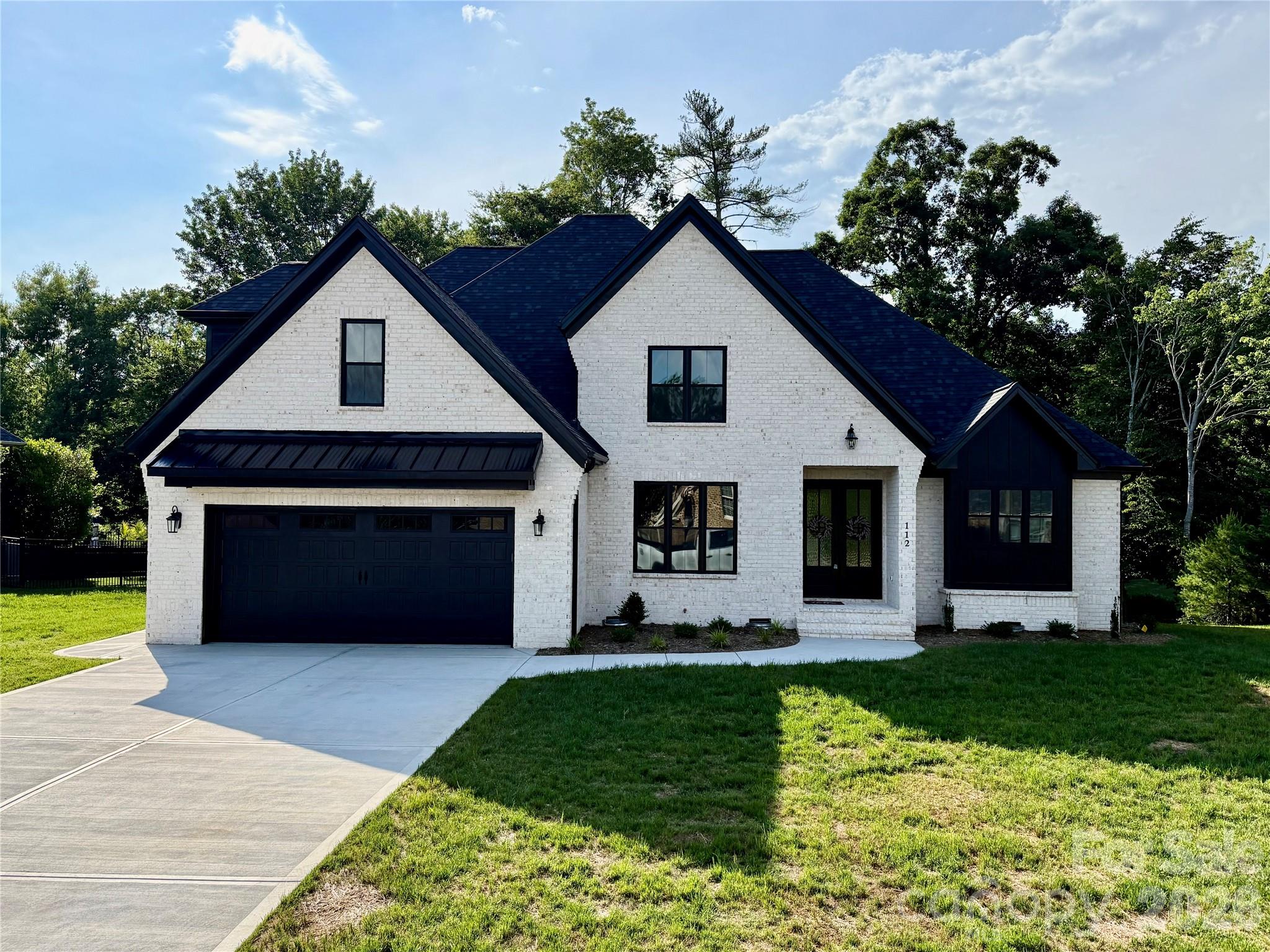 Welcome to this beautiful new construction home in the highly desirable Oliver's Landing community, perfectly situated on the 16th hole of Player's Ridge Golf Course. This spacious two-story home features 5 bedrooms, 4 full bathrooms, and an open floor plan designed for both everyday living and entertaining. The main living area offers soaring ceilings, modern lighting, and a stunning floor-to-ceiling stone fireplace. The kitchen is a standout with custom cabinetry, quartz countertops, stainless steel appliances, a large island, and a beverage bar with a built-in beverage fridge. The main-level owner's suite provides a relaxing retreat with a freestanding soaking tub, walk-in shower, and oversized walk-in closet. Also on the main floor, you'll find a formal dining room, breakfast area, laundry room, and a flexible space that can serve as a home office or sixth bedroom, along with a full bath.
Upstairs offers additional bedrooms with large closets, two full bathrooms, and a spacious bonus room perfect for a media room, or playroom. Enjoy peaceful golf course views from the covered back porch and experience all that Oliver's Landing has to offer. Don't miss your chance to own this exceptional home in one of the area's most sought-after neighborhoods.