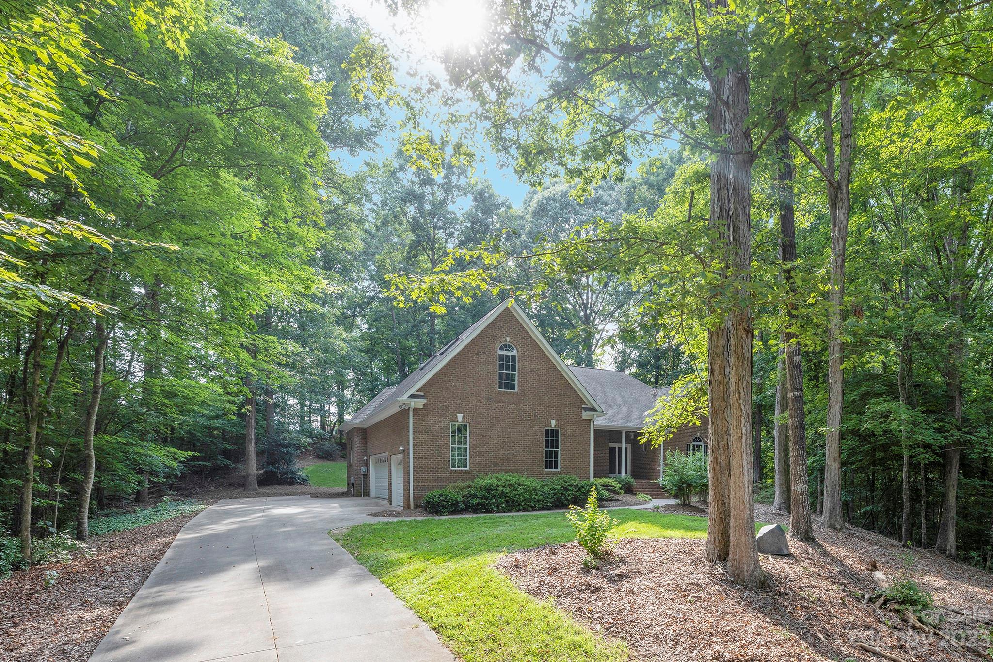 Rare opportunity in the very desirable Huntington Farms neighborhood! This Beautiful Brick home on 1.72 Acres offers you privacy within a neighborhood setting. This gem of a home has an extremely Open Plan with Loads of Light! The eat-in Kitchen with Breakfast Nook is open to Great Room and Formal Dining Area. There is a Home Office / Den with French Door also located in the heart of the home. The Primary suite is on the main level and has a Screened porch overlooking the beautiful wooded lot, perfect for enjoying your morning coffee. On the other side of the main level, you will find the Secondary Bedrooms and second full Bath. There are Wood Floors throughout main level. Upstairs is the Fourth Bedroom / Bonus Room with third Full Bathroom. There is a 3 Car-Garage and plenty of attic storage space. You can enjoy the wildlife from your covered front porch or back patio. This unique home is ready for your special touches to make it your own. Fresh paint throughout! Single Owner Home!