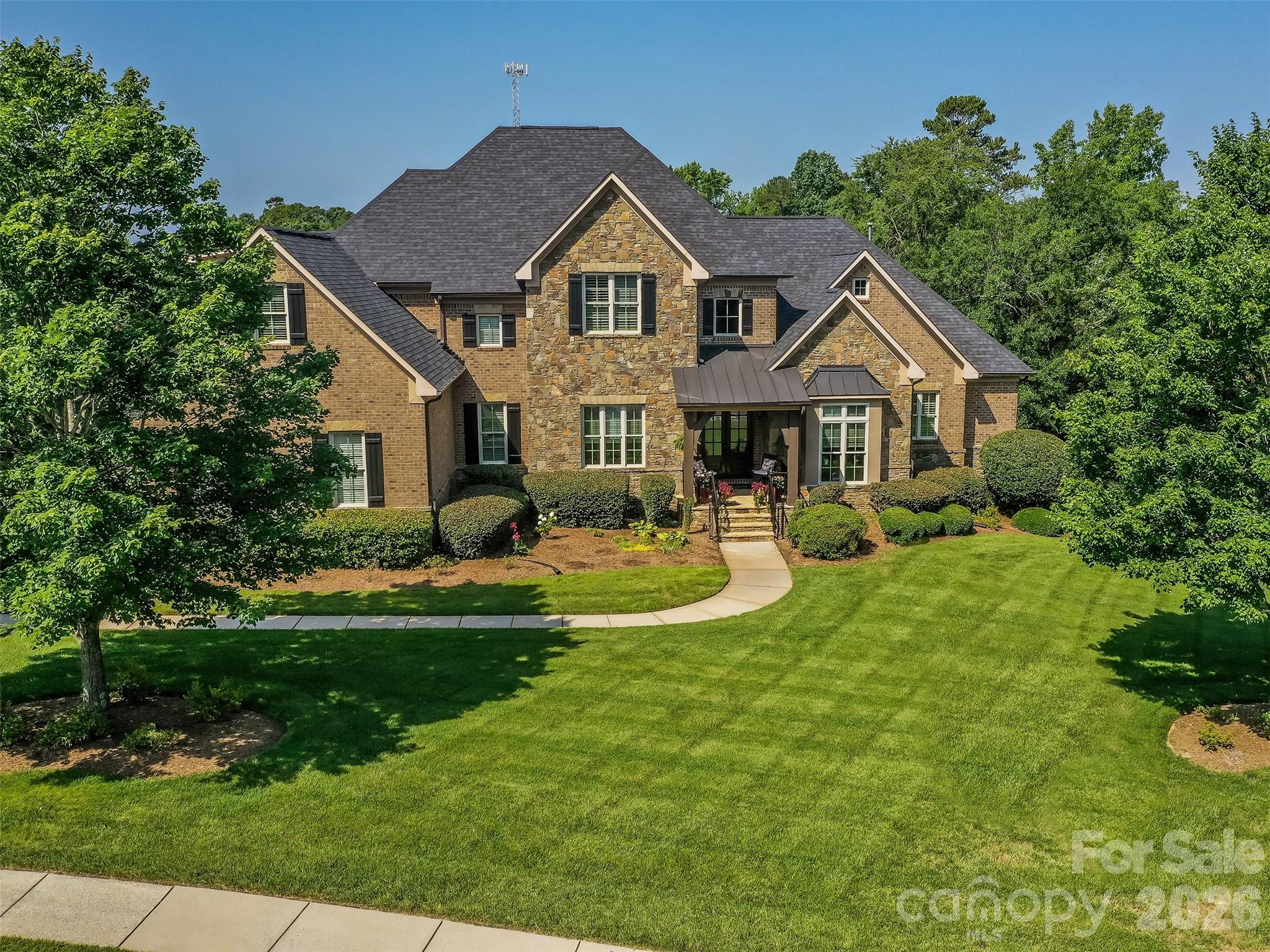 This spectacular custom home that is loaded with features now has had the interior completely repainted! The main floor features formal dining room, home office/study, great room with coffered ceilings, extensive molding, gourmet kitchen with HUGE Granite Island, stainless appliances, butler's pantry, breakfast area, den with vaulted ceiling & gas fireplace, guest suite with full bath, & an exceptional primary suite & sitting room, & primary bath with zero entry shower & soaking tub, & additional guest suite with full bath! The 2nd floor features a second primary suite, 2 additional guest suites, & a large Bonus Room with home theatre set up! The outdoor living spaces are unparalleled with custom screened porch & EZE Breeze windows, huge paver patio, hot tub, & covered outdoor kitchen with grill, fireplace, & TV that is perfect for enjoying weather in the Carolinas! New Roof, New Water Heater, & 3 NEW AC Units make this home perfect! Membership in CCOC is a must complete your new lifestyle!