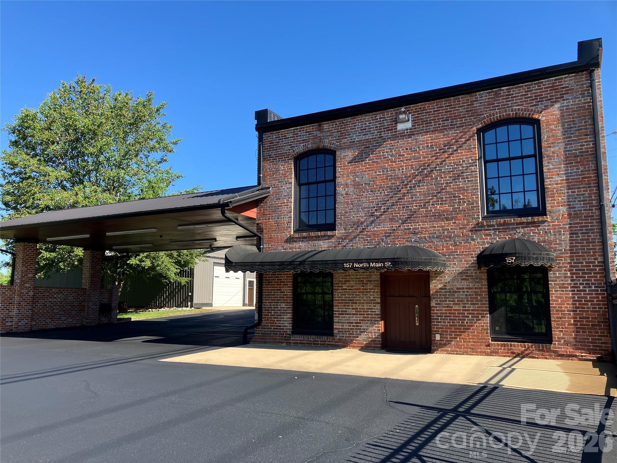 Remodeled historic brick office building in the heart of Bostic. Built by the Washburn family in 1897; lovingly restored over the last 20 years to better than new condition. Over 165’ of hand-painted mural art by well-known local artist Clive Haynes depicting historic Bostic as it was in the 1940’s adorn the walls. Original heartwood pine floors upstairs with full thickness oak wall panels and hand crafted oak window trim throughout. All new windows (completed in late 2025). All electrical, plumbing and structural modernization upgrades have been made. Wired for high-speed fiber-optic internet by Pangaea. LED lighting throughout. Security camera system included. The roof is standing seam metal with a 40 year warranty on top of all new trusses and new attic insulation (completed in 2020 at a cost of over $100k). Attached carport (45’x25’) and large detached garage/warehouse building (67’x30’). Large paved parking lot area that is partially fenced-in. No expense was spared during the restoration; all work was completed in the highest quality manner with long-term ownership and the historical significance of the building in mind.