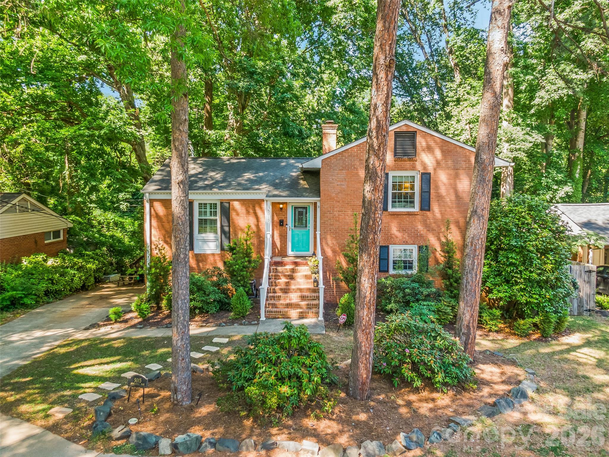 Madison Park living feels different, tucked beneath mature trees and moments from everything Charlotte has to offer, this beautifully updated full brick home blends warmth, character, and an unexpected sense of retreat.

Inside, hardwood floors run throughout the main and upper levels, complemented by plantation shutters, updated electrical, stainless steel appliances, granite countertops, and a timeless tile backsplash. The flexible layout offers a natural separation of spaces, with the primary suite privately positioned on the lower level featuring a custom closet, beautifully renovated bath with built-ins, convenient laundry access, and direct access outdoors.

Step outside and the story of this home really begins

A terraced yard with retaining walls, mature landscaping, and a large privacy fence create a backyard that feels tucked away from the city while still being right in the center of it all. Overlooking a peaceful creek, the outdoor space has already been thoughtfully transformed into a functional foundation for relaxing, entertaining, gardening, or creating your own personal outdoor oasis. Whether you envision evenings around a fire pit, expanding the garden, or simply enjoying the quiet surroundings, the possibilities here feel endless.

With two additional bedrooms on the upper level, generous storage throughout, and thoughtful improvements already in place, this home offers the rare combination of comfort, character, and opportunity all in one of Charlotte’s most beloved neighborhoods.