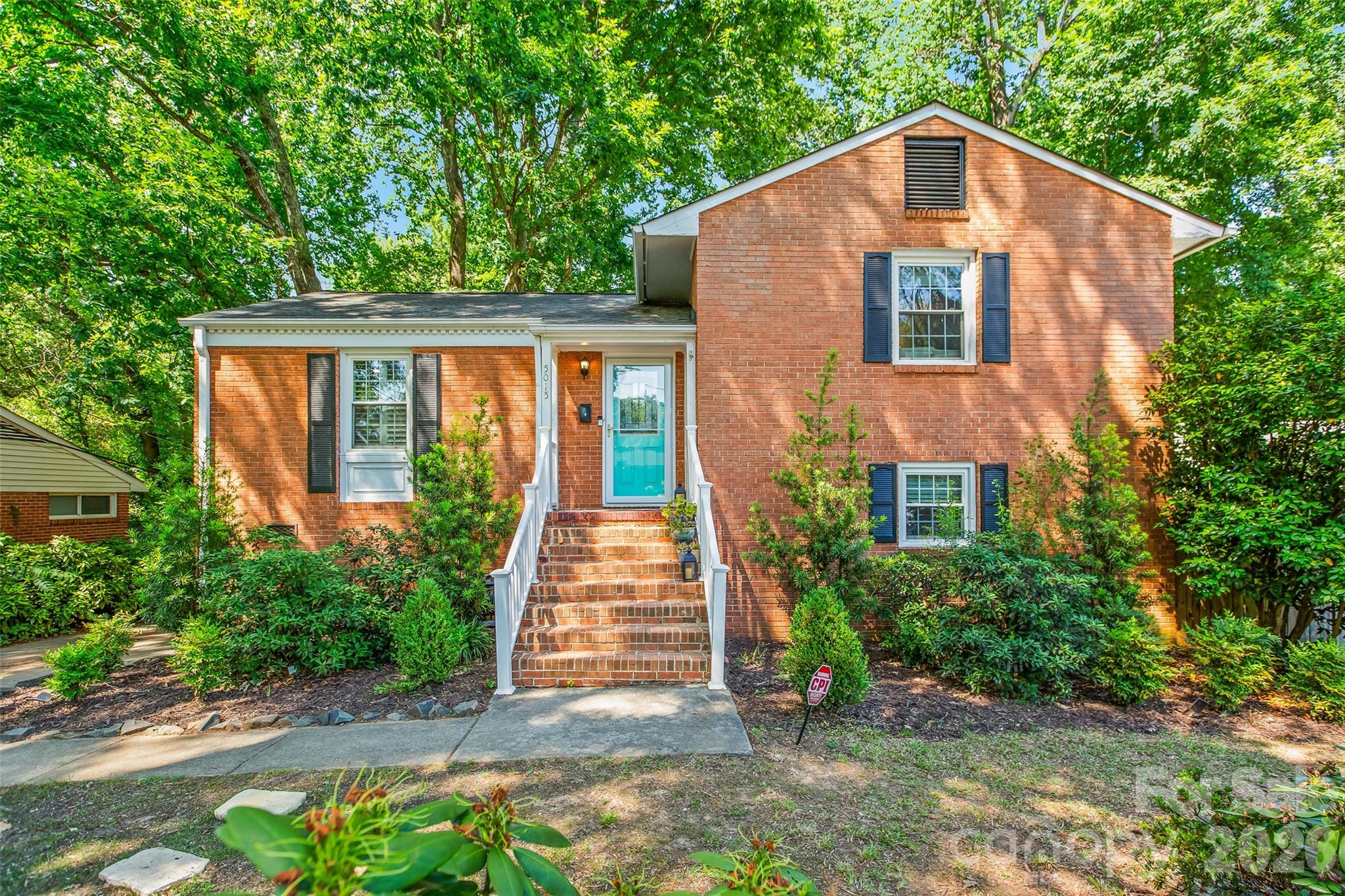 Madison Park living feels different. Tucked beneath mature trees and moments from everything Charlotte has to offer, this beautifully updated full brick home blends warmth, character, and an unexpected sense of retreat.

Inside, hardwood floors run throughout the main and upper levels, complemented by plantation shutters, updated electrical, stainless steel appliances, granite countertops, and a timeless tile backsplash. The flexible layout offers a natural separation of spaces, with the primary suite privately positioned on the lower level featuring a custom closet, beautifully renovated bath with built-ins, convenient laundry access, and direct access outdoors.

Step outside and the story of this home really begins.

A terraced yard with retaining walls, mature landscaping, and a large privacy fence create a backyard that feels tucked away from the city while still being right in the center of it all. Overlooking a peaceful creek, the outdoor space has already been thoughtfully transformed into a functional foundation for relaxing, entertaining, gardening, or creating your own personal outdoor oasis. Whether you envision evenings around a fire pit, expanding the garden, or simply enjoying the quiet surroundings, the possibilities here feel endless.

With two additional bedrooms on the upper level, generous storage throughout, and thoughtful improvements already in place, this home offers the rare combination of comfort, character, and opportunity, all in one of Charlotte's most beloved neighborhoods.