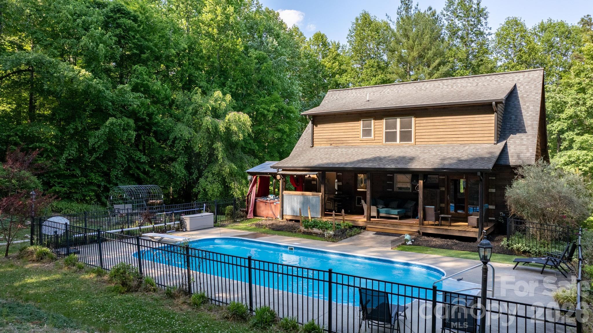 WELCOME HOME to this stunning log home retreat with a sparkling in-ground pool — just in time for summer! Nestled on a private 2.58-acre lot at the end of a long, wooded driveway, this property offers the perfect blend of rustic charm and peaceful seclusion. This home features 3 bedrooms, 2.5 bathrooms, a large bonus room, and a full basement. A full-length covered front porch welcomes you into the warm and inviting living room, complete with beautiful wood walls and flooring, plus a striking stone fireplace with gas logs. The kitchen and dining area provide the perfect gathering space for holidays, family meals, and entertaining. The main-level primary suite offers a large bedroom, walk-in closet, double vanities, a soaking tub, and separate shower. Upstairs, you’ll find two generously sized secondary bedrooms, a shared full bath, and a large bonus room ideal for a 4th bedroom, home office, playroom, or recreation space. Step outside to the covered back deck overlooking the gorgeous in-ground swimming pool — your own private oasis for relaxing or entertaining. A chicken coop is also included, adding extra charm and functionality to this unique property. Privacy, character, and outdoor living at its finest — don’t miss this one!