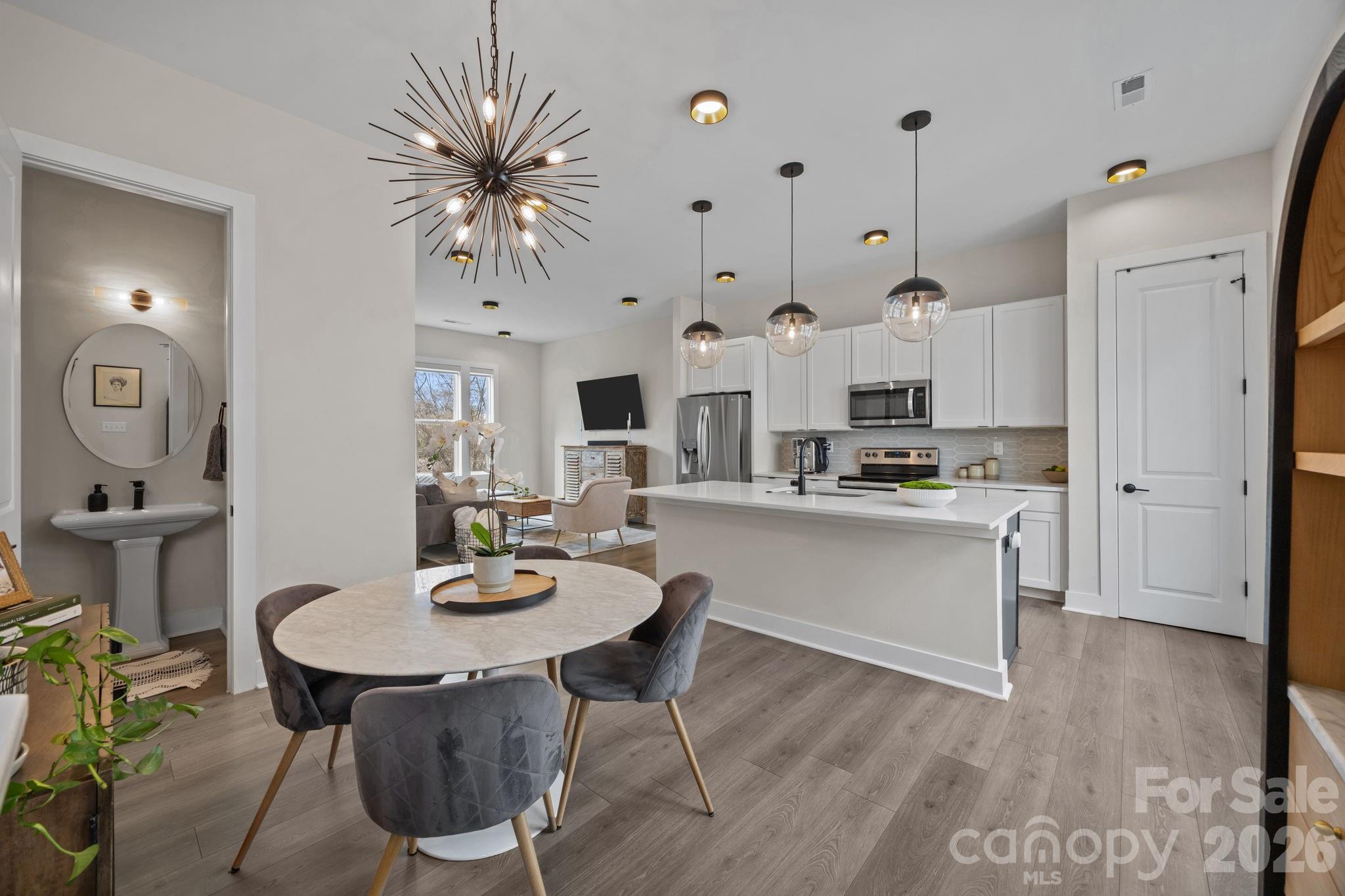 Luxury rooftop townhome with skyline views, a side-by-side 2-car garage, and a private rooftop terrace in Charlotte's highly desirable Belmont neighborhood just minutes from Uptown, NoDa, Plaza Midwood, and Optimist Hall. Built in 2023 by Copper Builders, this luxury 3BR/3.5BA townhome in Skyline Townes offers 1,720 heated sq ft of thoughtfully designed modern living. This Highland model townhome features a wider floor plan, high-end finishes, and clean architectural design throughout. The open-concept main living area flows seamlessly, making it ideal for both everyday living and entertaining. The kitchen showcases quartz countertops, two-tone cabinetry, stainless steel appliances, and designer lighting, while durable LVP flooring runs throughout the entire home.

A rare side-by-side 2-car garage with a 240V EV charging outlet adds everyday convenience, an uncommon find for in-town living. Zoned HVAC, and smart upgrades including CAT6 wiring and fiber internet support today's lifestyle needs. The true showstopper is the nearly 600 sq ft rooftop terrace designed for entertaining with unobstructed Charlotte skyline views, perfect for hosting, relaxing, or enjoying sunset evenings. Pre-wired for an outdoor TV and living space.

Located in one of Charlotte's most walkable and vibrant neighborhoods, you're just steps to Alexander Street Park (tennis courts and sports field), the Little Sugar Creek Greenway, Optimist Hall, breweries, restaurants, and local favorites like ACE No. 3 and Sweet Lew's BBQ (best brisket in the Charlotte). Easy access to I-277, I-77, I-85, light rail, and Uptown makes commuting effortless.

Flexible HOA allows both short-term and long-term rentals, ideal for a primary residence, second home, or investment opportunity. Small 21-unit community. Additional highlights include premium soundproofing between units, motorized shades, upgraded LED lighting, and a transferable 10-year structural warranty. This townhome delivers the perfect blend of modern construction, walkability, location, and lifestyle in Charlotte's highly sought-after Belmont corridor.