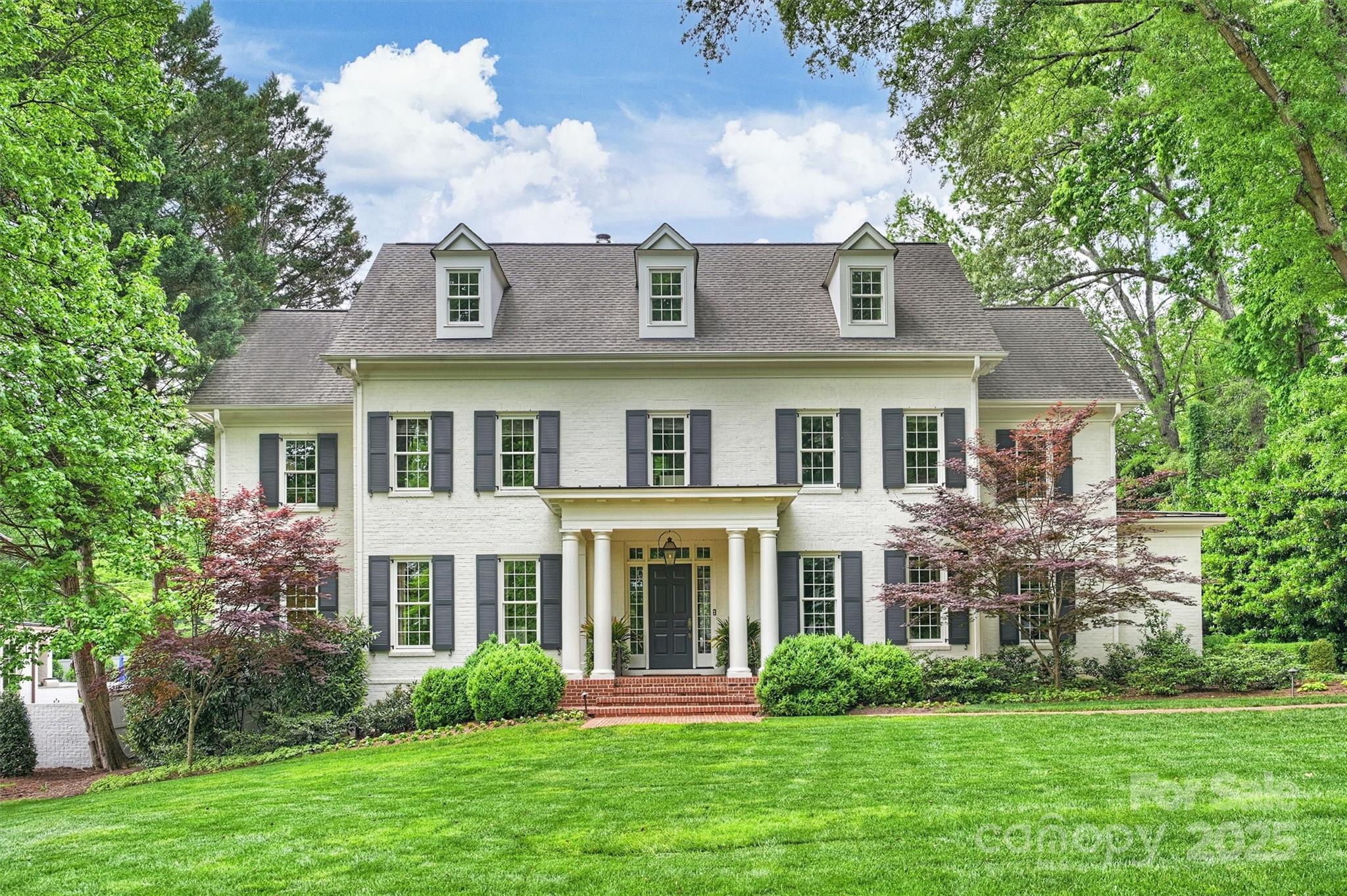 Gorgeous custom home located in highly sought-after Foxcroft! This classic gem boasts 2.5 stories of elegant design, featuring tall ceilings & doors, beautiful moldings and coffered ceilings. The inviting atmosphere is perfect for entertaining and everyday life. On the main level you will find the Primary Suite with vaulted ceiling, expansive windows, and an adjoining study. The beautiful kitchen opens to the family room, bar and dining room. Step outside to discover the gorgeous bluestone patio & screened porch with wood-burning fireplace, all overlooking the expansive, private, fully gated backyard. The side entrance leads to a thoughtfully designed drop zone w/ custom cabinetry. On the upper level, you will find 4 spacious en suite bedrooms, plus a separate lounge space. Don’t miss the 3rd floor bonus room, complete with a full bath. The detached garage has unfinished space ready to be customized to suit your needs. Take this opportunity to make this remarkable property your own!