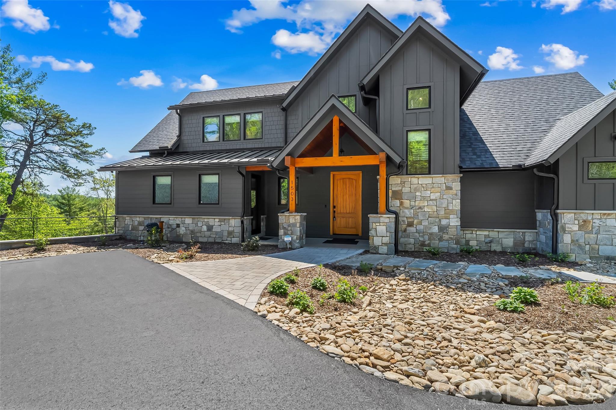 Welcome to an exceptional waterfront estate built in 2024, offering over 4,000 sq ft of meticulously designed living space on a private 12.7-acre parcel with 795 feet of stabilized shoreline. This contemporary home blends high-end finishes, thoughtful layout, and wonderful outdoor living spaces for buyers seeking privacy, luxury on a  private lakefront parcel. Step inside to an open, bright floorplan anchored by a gourmet kitchen featuring quartz countertops, a large island perfect for casual dining and entertaining, and top-tier stainless steel appliances. An oversized awning window opens to the screened porch creating a seamless indoor-outdoor connection. The main level hosts the luxurious primary suite with an elegant ensuite bath, offering privacy and single-floor convenience. Elevator access provides effortless movement between floors. The second floor delivers two generous bedrooms, each with private ensuite baths, plus a versatile loft space.  The lower-level walkout is an entertainer’s dream: a full bedroom with ensuite, a complete second kitchen for independent living or large gatherings, a spacious family room, exercise room, flex room, and a dedicated office. Practical touches include a second washer/dryer in the basement and an on-demand water heater for efficiency. A whole-house standby generator ensures uninterrupted comfort and peace of mind. Outdoor living is designed for enjoyment and durability. Hardscaping and a patio with a gas fire pit create an inviting gathering spot, while a hookup is ready for a hot tub. The property’s waterfront amenities are outstanding: a covered single-slip floating dock with lift, composite decking, and a metal roof make boating and lakeside lounging effortless. Nearly 800 feet of stabilized shoreline guarantees privacy and long-term waterfront integrity. Durable, low-maintenance exterior materials include Hardie board siding and stone. Additionally a detached two-car garage equipped with HVAC and Wi-Fi and cold water sink for workshop convenience, and a long drive that enhances the sense of seclusion while providing ample parking for guests.
This estate is thoughtfully appointed for multi-generational living, entertaining, or year-round retreat use. High-end finishes, abundant natural light, flexible living spaces, and unparalleled waterfront access combine to create a property that satisfies both practical needs and lifestyle aspirations. Experience waterfront living without compromise.  Community amenities include open pavilions at the lake Camp and River Camp. Miles of walking trails, community building and full time on site caretaker.  Just 15 minutes to Marion shops, restaurants and entertainment.