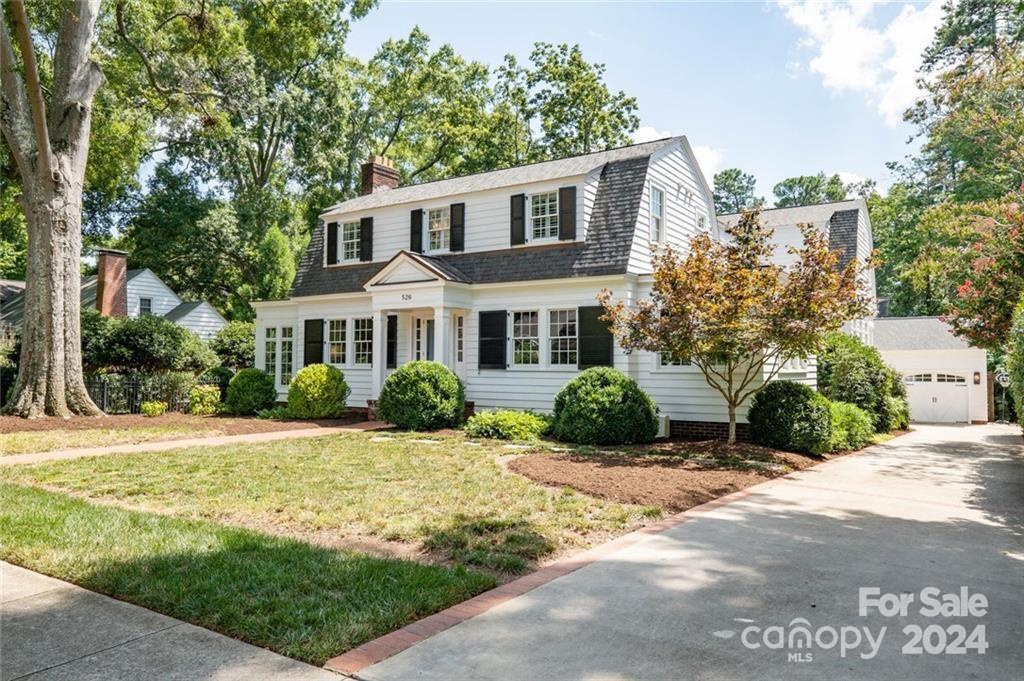 This historic Dutch-Colonial Revival home was completed May 1929 by George Watts, a professor at Davidson College. The property was beautifully restored and expanded in 2016, by CM Knight Fine Homes to 3895 sf which includes 4 bedrooms, 3.5 baths, spacious great room with fireplace and a wall of windows! The kitchen is accented with marble counters, walnut top island, Wolfe range, wine cooler, pantry & built-in pantry cabinets which provide ample storage. Butlers pantry bridges to formal dining room embellished with wood trim. Private library-study, sunroom & office gives balance to the main floor. Gleaming hardwood floors & arched doorways add to the architectural character. Natural light inundates entire home. Outdoor stone patio, brick fireplace, quaint garden area with fountain surrounded by mature trees & flowers make entertaining a pleasure. The detached garage features built-in shelving & flex area. 
*Garage "roof" plans for additional bonus/guest suite*
*we love buyer agents*