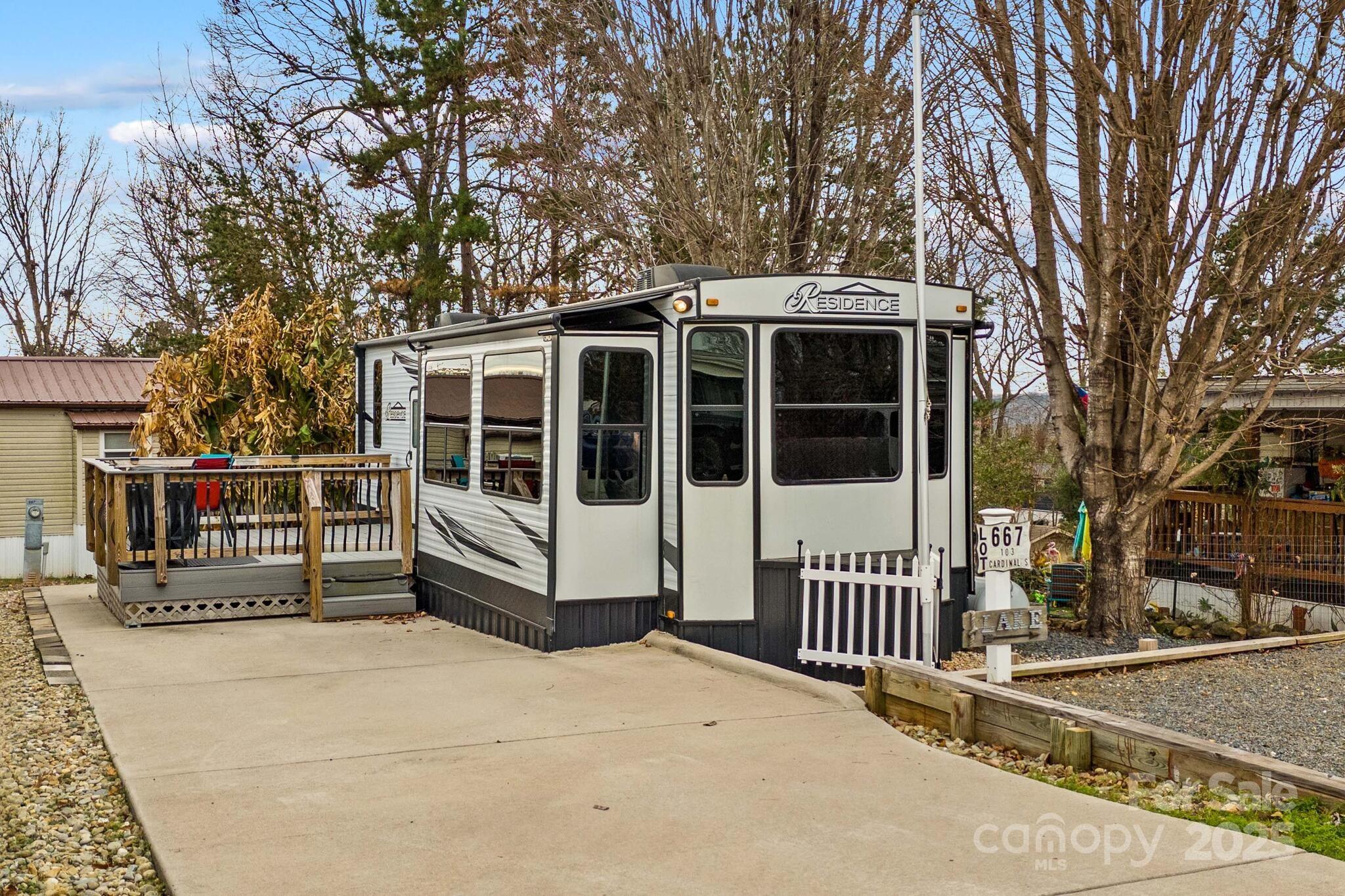 Escape to effortless lakeside living with this beautifully maintained 2021 destination camper, situated on a level, deeded lot in the sought-after Badin Shores Resort at Badin Lake. Designed for comfort and convenience, the camper features two bedrooms, one bath, stainless steel appliances, and a cozy electric fireplace—perfect for relaxing after a day on the water. Outside, a concrete parking pad and deck provide ideal space to unwind and take in the peaceful surroundings. Enjoy all the perks of resort living, including a swimming pool, fishing pier, basketball courts, boat ramp, putt-putt golf, clubhouse, playgrounds, and picnic pavilion. Whether you’re seeking a weekend retreat or a low-maintenance getaway, this charming lakeside property offers endless opportunities for recreation and relaxation