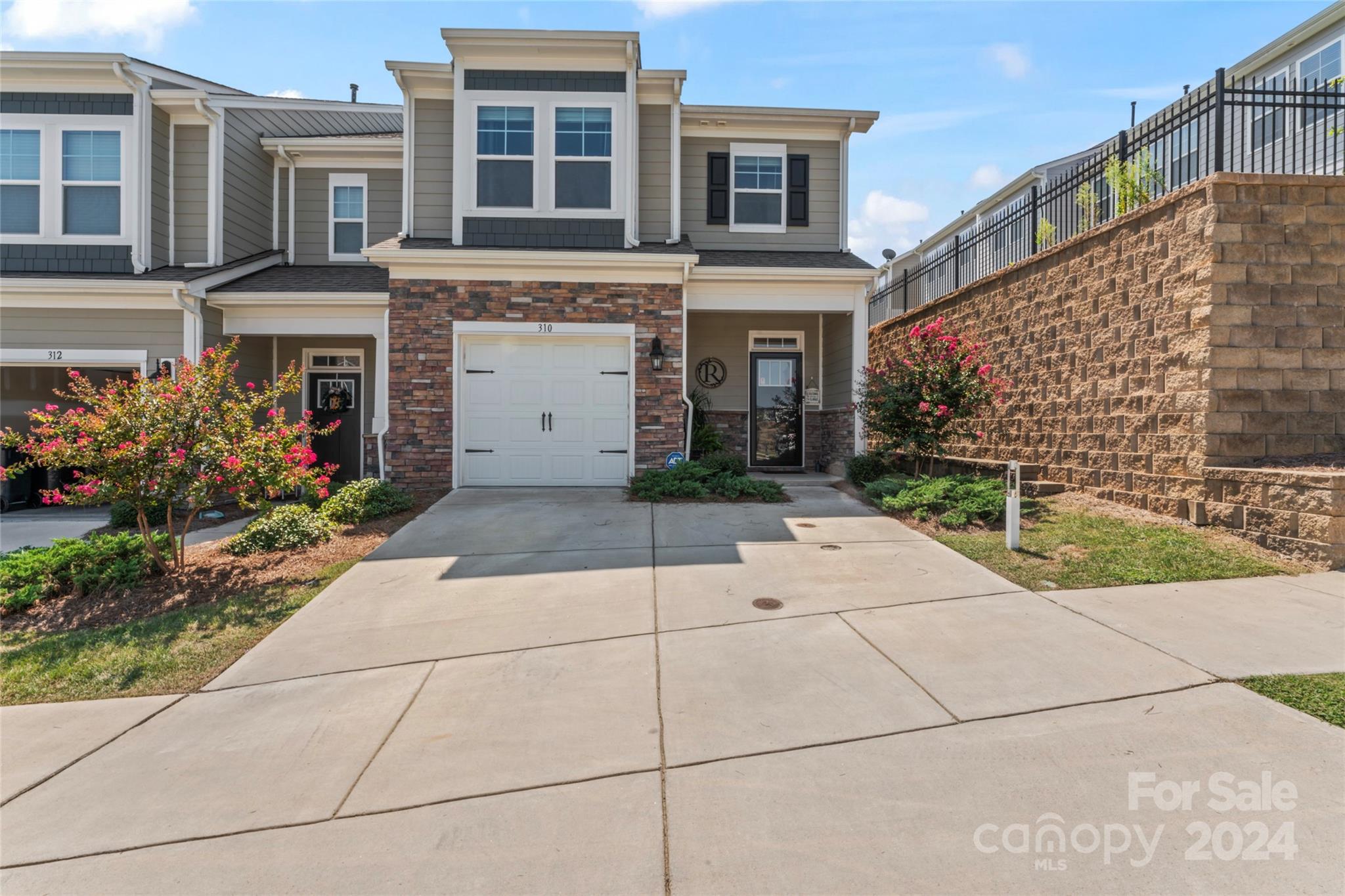 BEAUTIFUL TOWNHOUSE ALERT! This 3-bedroom 2.5 bath townhouse in Lake Wylie is 25 mins from Charlotte, which allows you to enjoy the lake life and have quick access to the city life as well. It offers an open floorplan with beautiful 7.5 inch Revwood flooring and crown molding throughout the first floor. The kitchen has granite countertops, a huge island, subway tile backsplash, pantry and gas range. You can retreat to the upper level in the oversized primary bedroom with ensuite including a large shower, dual vanities with granite top and huge walk-in closet. There are two other spacious bedrooms on this floor with full bathroom and laundry room. The outdoor space offers an extended patio which is great for entertaining. Irrigation and full yard maintenance is included - this is Maintenance free living at its best! You also have access to the community pool, clubhouse, playground, Bocce Ball court and picnic area. Come see this townhouse before it gets snatched up!