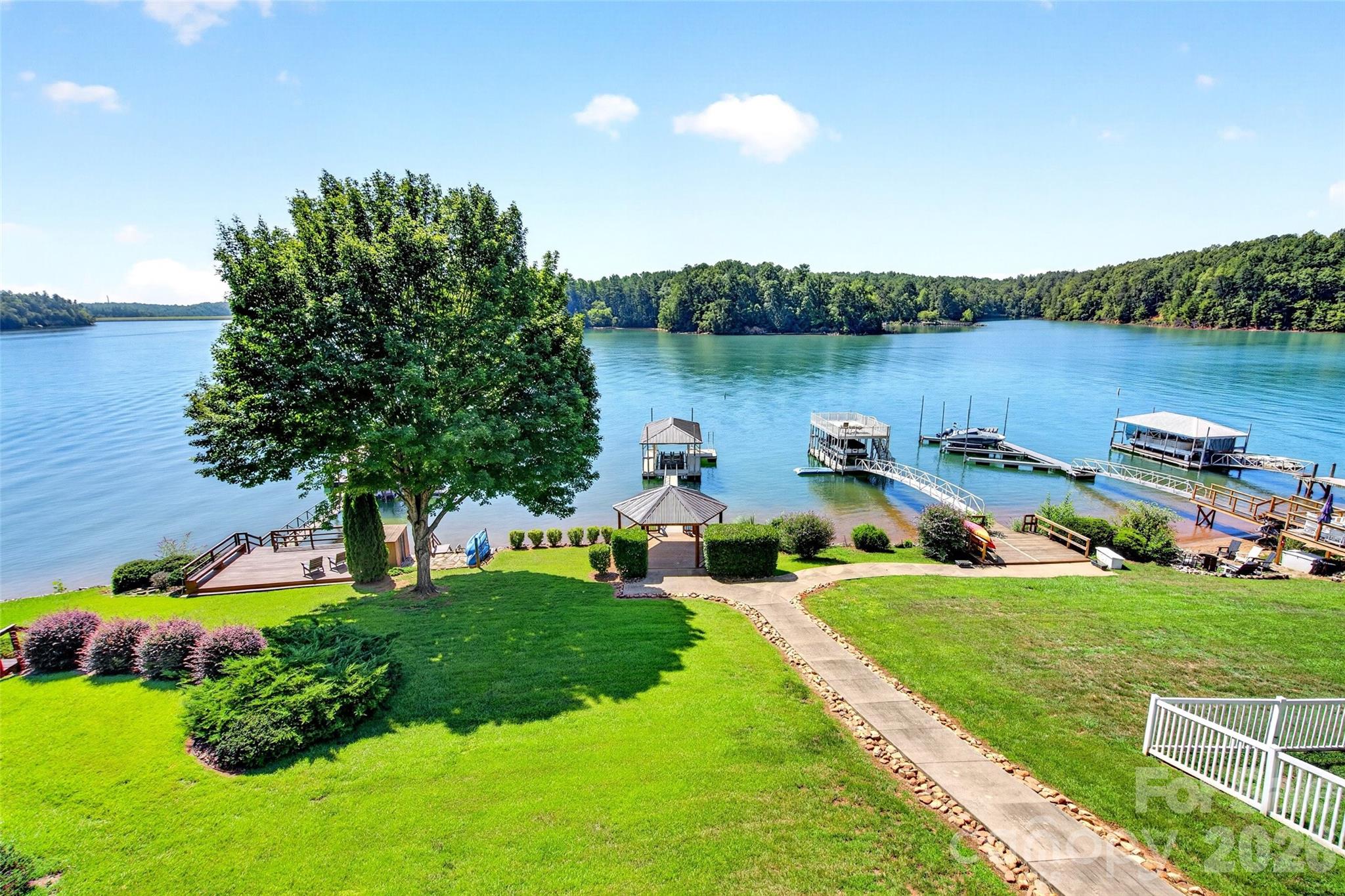Tucked into the coveted Marion Lake Club community, this 3-bedroom, 3.5-bath waterfront haven spans 3,060 square feet of impeccable craftsmanship and lake-life luxury. From the moment you arrive, the home's exterior—wrapped entirely in rock and brick back in 2008—makes a bold first impression and promises quality built to endure.


Inside, the details speak volumes: hickory hardwood floors, custom hickory cabinets, quartz countertops in the kitchen and baths, plantation shutters, Roman shades, and gas logs that make chilly mountain evenings downright cozy. Tinted glass windows on the lake side frame those amazing views without the glare, while a generous laundry room keeps everyday living effortless. Downstairs, a spacious game room, two full baths, and a second primary bedroom with ceramic wood flooring create the perfect retreat for guests or gatherings. The large walk-in closet on Lower level was previously a 3rd bedroom, which could easily be converted back to a bedroom again. 


The outdoor space is where this property truly shines. Weather-resistant IPE wood decks, an outdoor kitchenette, and a back porch positioned to catch glorious sunrises invite you to linger. A finished gazebo with electricity, a private boat dock with lift for a triple pontoon, swim ladder, and sun deck complete the waterfront dream. Brown metal roofs on the house, gazebo, and dock add lasting durability, and a brand-new electrical panel keeps everything modern.


Beyond your doorstep, Lake James State Park, the Fonta Flora State Trail, and the Marion Lake Club dining scene are all just minutes away.


Waterfront quality like this rarely surfaces. Schedule your private showing before it slips away.