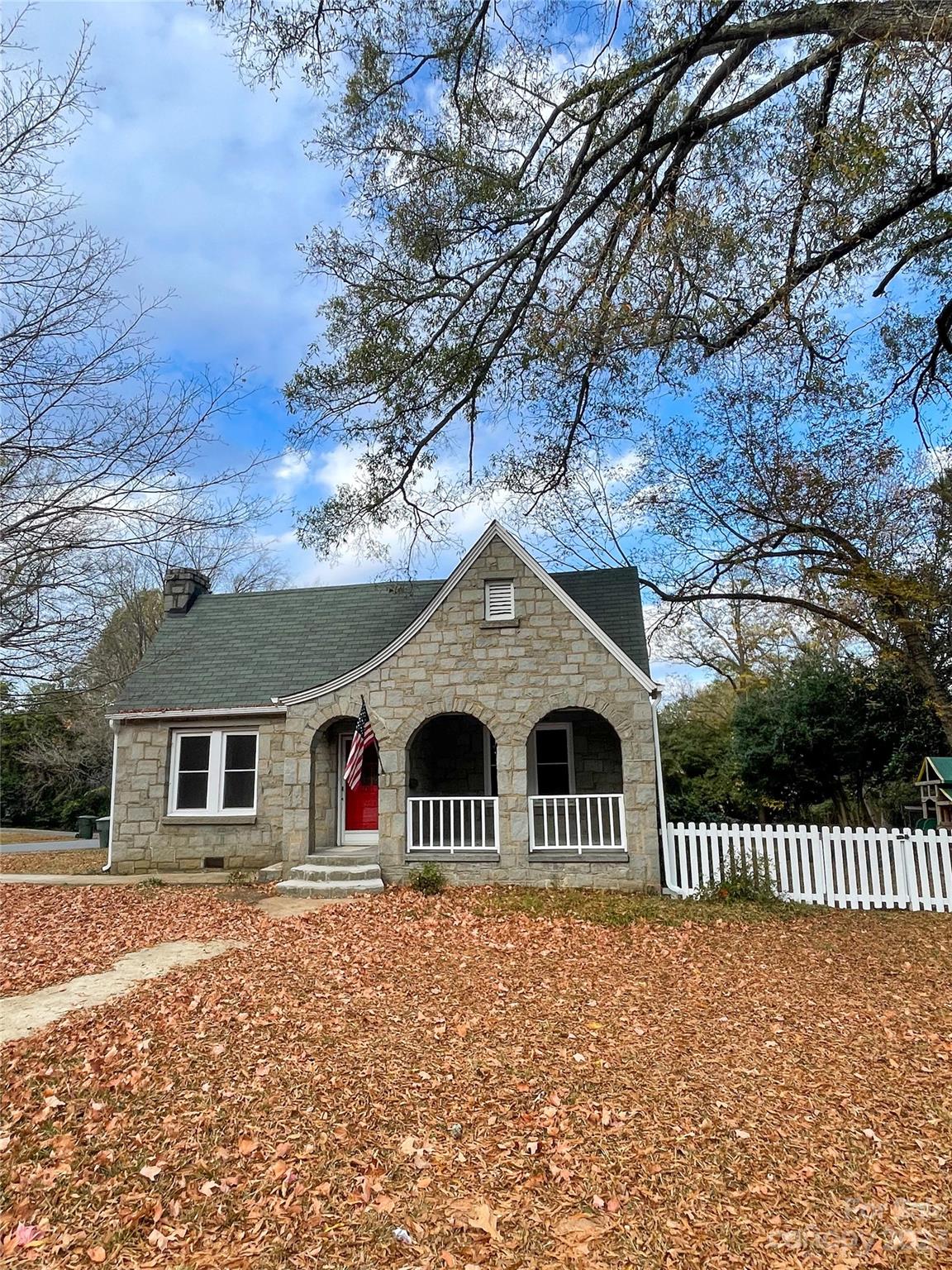 Fully remodeled stone house—Old charm, New features. 3bd/2ba, beautiful, newly refinished hard wood floors. New cabinets in kitchen with quartz countertops, large dining room, vinyl replacement windows. House is on level, corner lot in great location. Walk to shopping and dining. A unique opportunity to own a special home.