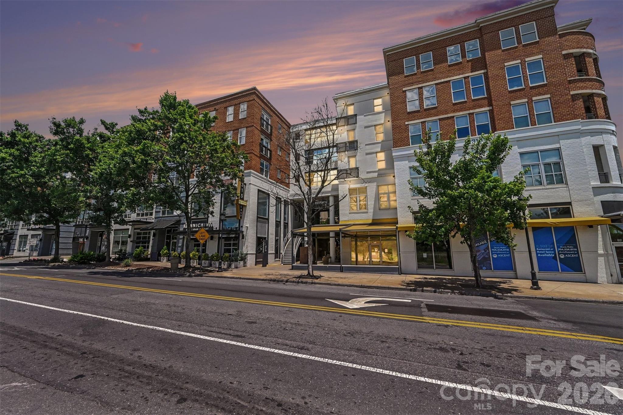 Welcome home to this beautiful, sun-filled condo perfectly situated in the heart of historic Dilworth. Boasting one of the largest floor plans in the building, this immaculate two-bedroom, two-bathroom residence offers an ideal split-bedroom layout for maximum privacy, seamlessly connected by a bright, open-concept living, dining, and kitchen area. The oversized primary suite features a generous walk-in closet and deluxe ensuite bath, while the spacious guest room accesses a full hallway bath, perfect for visitors. The cheerful living room showcases elegant custom built-in cabinetry and flows directly onto a private balcony, ideal for enjoying the sights and sounds of the Queen City. Take advantage of the fully equipped on-site fitness center and an expansive rooftop terrace with stunning views. Experience the unbeatable convenience in Charlotte's most walkable neighborhood. You are just minutes away from Freedom Park, South End, Midtown, and the finest local dining and boutique shopping!