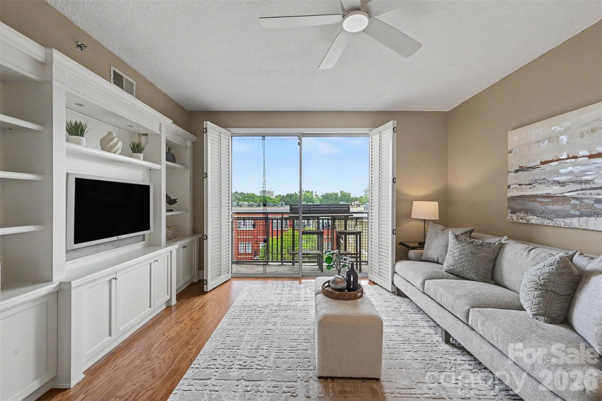 Welcome home to this beautiful, sun-filled condo perfectly situated in the heart of historic Dilworth. Boasting one of the largest floor plans in the building, this immaculate two-bedroom, two-bathroom residence offers an ideal split-bedroom layout for maximum privacy, seamlessly connected by a bright, open-concept living, dining, and kitchen area. The oversized primary suite features a generous walk-in closet and deluxe ensuite bath, while the spacious guest room accesses a full hallway bath, perfect for visitors. The cheerful living room showcases elegant custom built-in cabinetry and flows directly onto a private balcony, ideal for enjoying the sights and sounds of the Queen City. Take advantage of the fully equipped on-site fitness center and an expansive rooftop terrace with stunning views. Experience the unbeatable convenience in Charlotte's most walkable neighborhood. You are just minutes away from Freedom Park, South End, Midtown, and the finest local dining and boutique shopping!