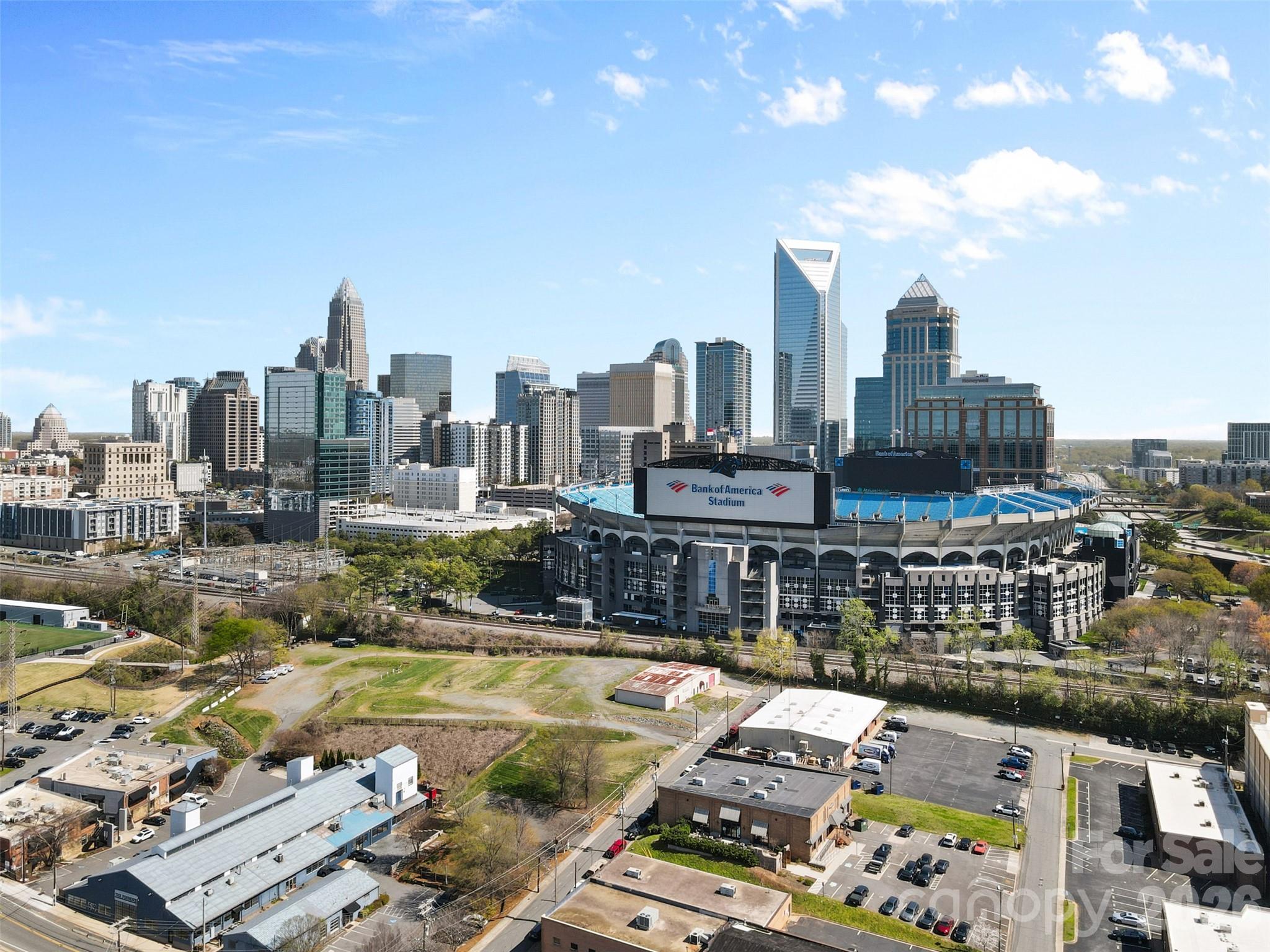 This incredible 3rd Ward loft offers the perfect blend of style, space, and location. Just steps from Bank of America Stadium (home of the Carolina Panthers & Charlotte FC, it’s ideal for game day tailgates and enjoying all that Uptown and South End have to offer. The expansive great room features soaring 20’ ceilings, creating an open and inviting space perfect for entertaining. The kitchen flows seamlessly into the living area, while a guest suite with a full bath adds convenience on the main level. Upstairs, the spacious primary suite includes an updated bath with dual vanities and an office nook for working from home. With its unbeatable location and standout features, schedule your tours this one wont last long!