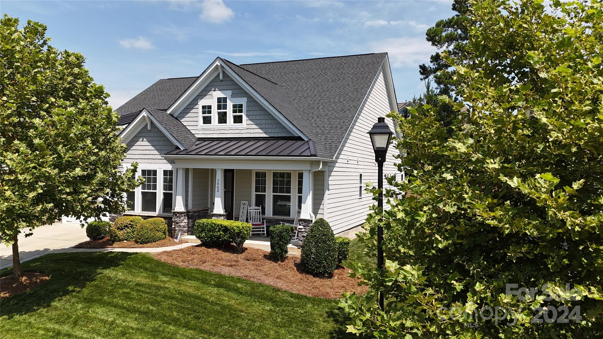 Welcome to Bent Creek! A Craftsman-style home featuring 4 bedrooms/4.5 bathrooms with signature upgrades, cutting-edge technology, and open-concept dining, kitchen & family room. The chef's kitchen features upgraded stainless steel appliances including a smart Monogram wall oven & dishwasher; gas range/designer hood & microwave; oversized kitchen island, granite countertops, 42" gourmet cabinets with crown molding accented by a beautiful backsplash, & undercabinet & halo lighting. The main floor owner's retreat features a luxury-spa-like ensuite bathroom with dual vanities, a large tiled shower & a huge walk-in closet. The 3 additional bedrooms have ensuite/adjacent baths. Features: Office/Dining Room, laundry room, a large family loft, keyless entry technology & more! The covered back porch is open to a stone patio & wood-burning chimney for outdoor entertaining. Enjoy the resort-style pool, clubhouse or state-of-the-art fitness center & playground. Minutes from Waxhaw/Indian Land.