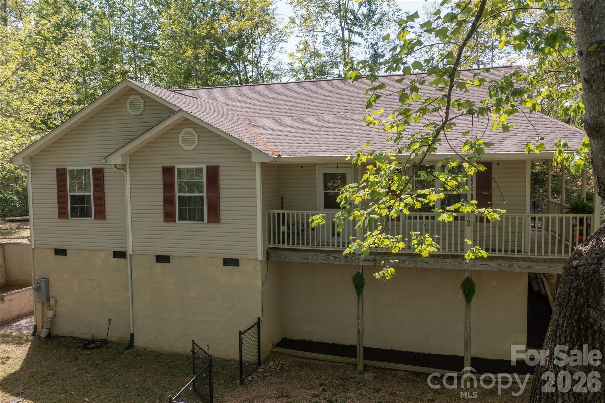 Totally charming well maintained home in a wooded neighborhood between Hendersonville and Fletcher and only about 10 min to Advent Health Hospital. Privacy and one level living. Large kitchen includes a breakfast nook and island. Kitchen is open to a spacious family room area with living and dining area adjacent.  3 ample bedrooms with walk in closets, primary bedroom has en suite bath with  a garden tub, sit down vanity and shower/commode room. Centrally located laundry room convenient to bedrooms. Recent LVP flooring throughout. Recent roof. High, oversized crawl space with newly insalled vapor barrier. Room for addiitonal storage. Outside there is a sizeable fenced area for pets.  This home feels like a cozy mountain retreat.