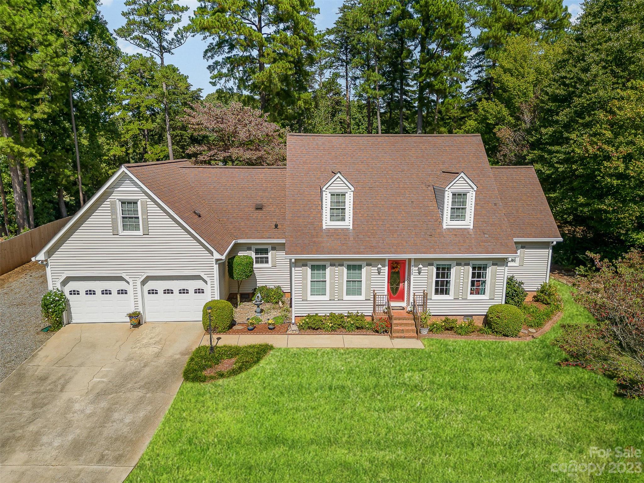 HUGE PRICE IMPROVEMENT and FRESH COSMETIC UPDATES on this beautifully custom crafted 3-bedroom, 2.5-bathroom Cape Cod home situated on the prestigious Westport Golf Course. Nestled on the 13th tee box with views of the 12th green in a LAKE FRONT community. The property has been meticulously maintained inside and out and offers many custom features such as white oak floors, granite on all counters, solid wood kitchen cabinets and solid interior doors. The primary suite on the main level is a tranquil oasis with an en-suite bathroom and oversized closet space. Wake up to the beauty of your own private deck with a view of  flowers, trees, and plants.  Each additional bedroom on the upper level boasts its own walk-in closet. The substantial bonus room provides versatile living space with convenient walk-in attic storage space. The Westport Club offers golf, swim and tennis with full membership or al a carte memberships. Located .5 miles from Lake Norman and 20 miles from Charlotte.
