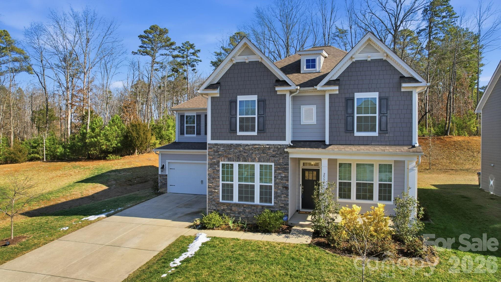 Welcome home to this beautiful move-in ready home situated on a private tree-lined lot on a cul-de-sac with no neighbors on one side and no homes behind! Located in the desirable Cypress Point subdivision in Lake Wylie, This stunning 5 bedroom, 4.5 bath home offers a spacious and functional layout with high-end finishes throughout. From the moment you step inside, you’re greeted by coffered ceilings in the light-filled dining room and French doors leading to a private office.Oversized windows flood the home with natural light, creating a bright and inviting atmosphere throughout. The expansive and open main living area is anchored by a stone fireplace for cozy nights by the fire and the kitchen includes a gas range, double ovens and a large island with Quartz countertops and seating great for entertaining. The main floor also has a guest bedroom with private bathroom. Upstairs is the incredibly spacious and luxurious primary suite with trey ceiling, bath with semi-frameless shower and soaking tub and large walk in closet. There are 3 additional bedrooms and an epic bonus room that can be utilized in many ways, for media, play or recreation. Laundry Rm. is located upstairs. Step outside to a private and beautiful backyard retreat on the covered rear patio with the serenity of peaceful wooded views and nights by the built in fire pit.Refrigerator, washer, and dryer convey—making this truly move-in ready.Exterior features include hardboard siding and architectural shingles for lasting curb appeal. Two-car garage. Cypress Point amenities include a clubhouse, pool, fitness center, game court, picnic area and playground and there are many community events throughout the year. 
This one checks every box—space, style, privacy, and amenities!