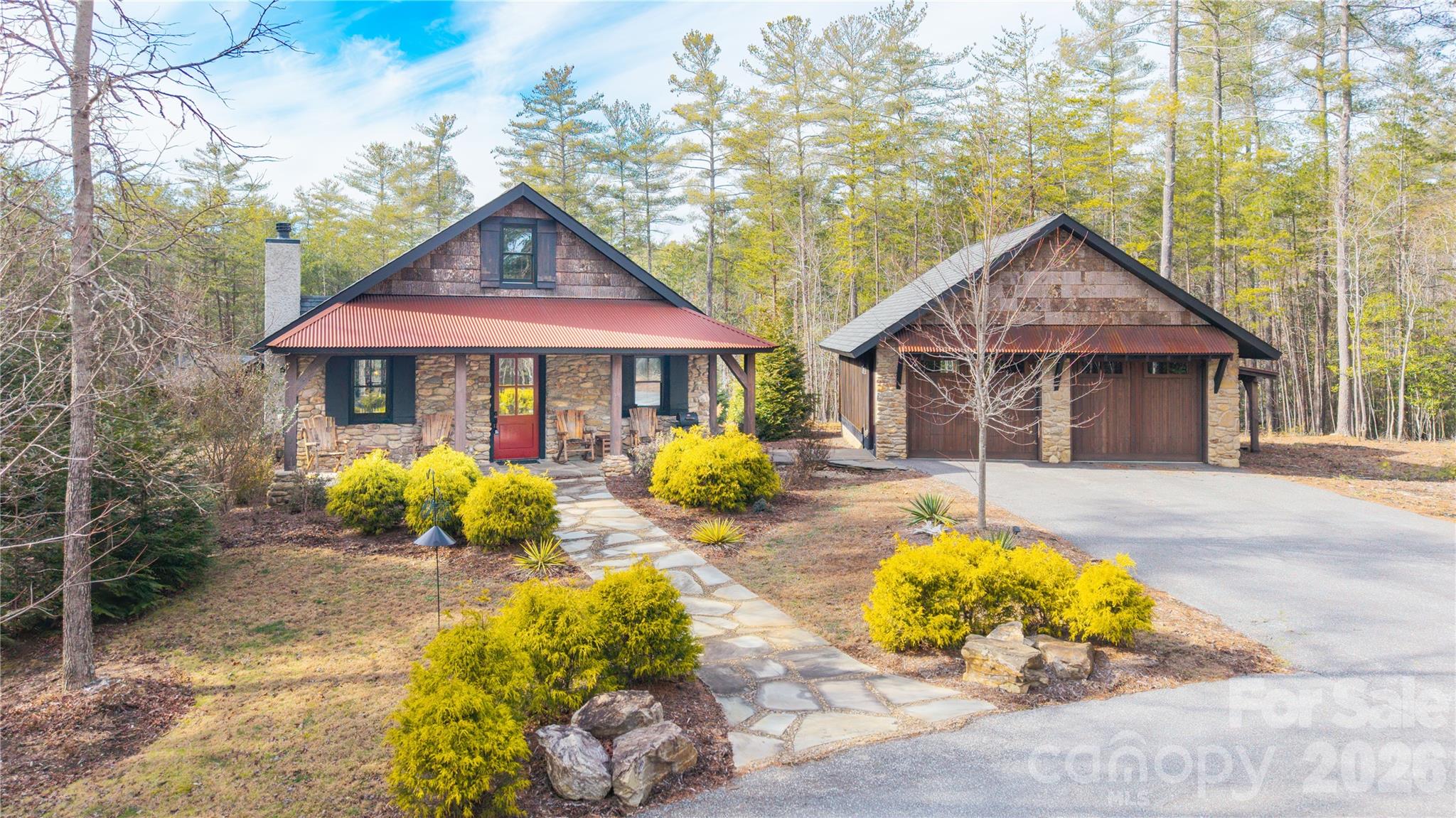Rustic modern cottage in the 1780 subdivision on Lake James offering privacy, acreage, and premier community amenities. Situated on over 2.5 acres, this 3BR/2BA home blends warm wood accents with clean modern design.  One level living and an open-concept layout make it ideal for gathering and entertaining.. Outdoor living shines with a covered pavilion featuring a fireplace, plus a separate fire pit area for evenings under the stars. Includes a deeded boat slip(H1 at Cornwallis docks) for easy lake access and a detached garage for additional storage, vehicles, or lake toys along with covered ATV parking. Conveniently located near Lake James State Park and Fonta Flora Brewery at Whippoorwill Farm with easy access to I-40. Property includes membership to Camp Lake James with access to pickleball courts, resort size pool, hot tub, and social hall with dining and events.Close to miles of trails for the outdoor enthusiast. Ideal as a full-time residence, vacation retreat, or investment opportunity(this property does NOT allow STR) in one of Lake James’ most sought-after communities. Lake days. Cozy nights by the fire. Space to breathe….