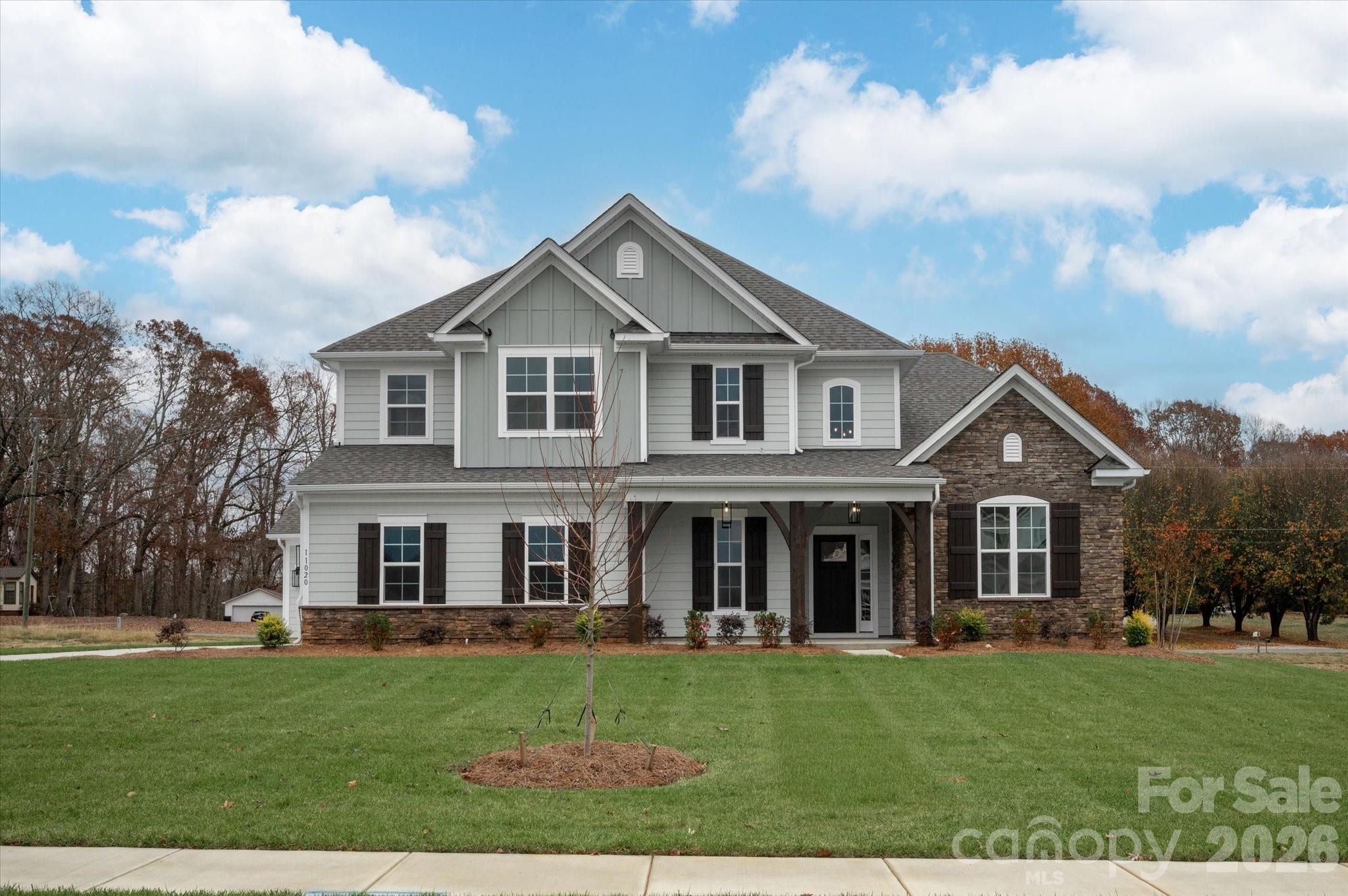 New home in Mint Hill with striking design and architectural features, including a two-story foyer, statement Dining room with arched entry, columns, and 12' ceiling. This home offers a first-floor Primary Suite AND guest bedroom and full bath with walk-in shower. The mudroom has all the conveniences with large drop zone, coat closet and laundry room to greet you as you come in from the garage. 2-car side entry garage and separate carriage garage, ideal for additional car, workshop, or storage with its own door. Easily entertain in the open living space, which flows to the large rear covered porch. Family room has built-in niches with cabinet and shelves by the gas fireplace with white Italian marble surround. Gourmet kitchen boasts 42" cabinets, quartz counters, mosaic tile backsplash, LED under-cabinet lights, soft-close doors/drawers, double trash pullout, and GE Profile stainless steel appliances with 36" gas cooktop and extraction hood vented outside, plus large undermount sink. Main floor Premier Suite features tray ceiling, bay window sitting area, walk in closet, and bathroom with white cabinets, quartz counters, soaking tub, tiled shower with shampoo niche and bench, semi-frameless glass, and tiled floor. Upstairs is a loft with room for desks, and step up to the large Rec Room with walk-in attic storage. One bedroom has a private bath. All secondary baths have raised height vanities, matte black hardware, quartz counters and tiled floors. Main living areas have 6.5" Hickory hardwoods, oak treads on stairs. The home sits on a .51 acre flat lot with fescue sod and irrigation on three sides. Other highlights are outdoor speakers on the rear covered porch and a tankless water heater. Just 4 miles from downtown Mint Hill for shopping and dining and 1.5 miles to access I-485. Special Incentive available for rate buydown, closing costs, move-in package. Contact us for details.