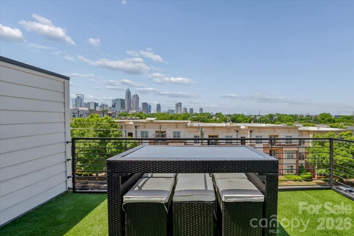 Welcome to elevated urban living in the heart of Charlotte. Located in the highly sought-after Central Point community, this exceptional four-story end-unit townhome at 12057 Brooklyn Ave offers the perfect blend of luxury, functionality, and an unbeatable location—just steps from the Little Sugar Creek Greenway and minutes to Uptown Charlotte, Plaza Midwood, and NoDa.

Thoughtfully designed to mirror the model home, this one-owner residence showcases top-of-the-line upgrades throughout while still feeling like new construction. As an end unit, it features additional windows that flood the home with natural light, enhanced by automatic shades for both convenience and style, and beautifully highlighting the hardwood floors that run throughout the main living spaces.

The main level is designed for both everyday living and effortless entertaining. A stunning chef’s kitchen anchors the space, complete with high-end coordinating appliances, an oversized island with breakfast bar, abundant cabinetry, generous counter space, and a pantry. The kitchen flows seamlessly into the dining area and spacious living room, while a private balcony just off the kitchen provides the perfect spot for grilling, relaxing, or enjoying fresh air.

Upstairs, the spacious owner’s suite offers a true retreat, complemented by a spa-like bath and ample closet space. Two additional bedrooms each feature their own en-suite bathrooms and walk-in closets, providing privacy and flexibility for guests, roommates, or a home office setup.

One of the home’s most impressive features is the private rooftop terrace—an ideal setting for relaxing or entertaining with sweeping views of the Charlotte skyline. Whether you're enjoying a quiet morning coffee or unwinding by a fire pit at sunset, this space delivers a rare and elevated outdoor experience.

Additional highlights include a tandem two-car garage. Outdoor enthusiasts will love the immediate access to miles of greenway trails, while city lovers will appreciate quick access to I-277 and close proximity to Charlotte’s best dining, breweries, shopping, and entertainment.

This is a rare opportunity to own a low-maintenance, luxury townhome in one of Charlotte’s most vibrant and connected neighborhoods—perfect for both homeowners and investors alike.