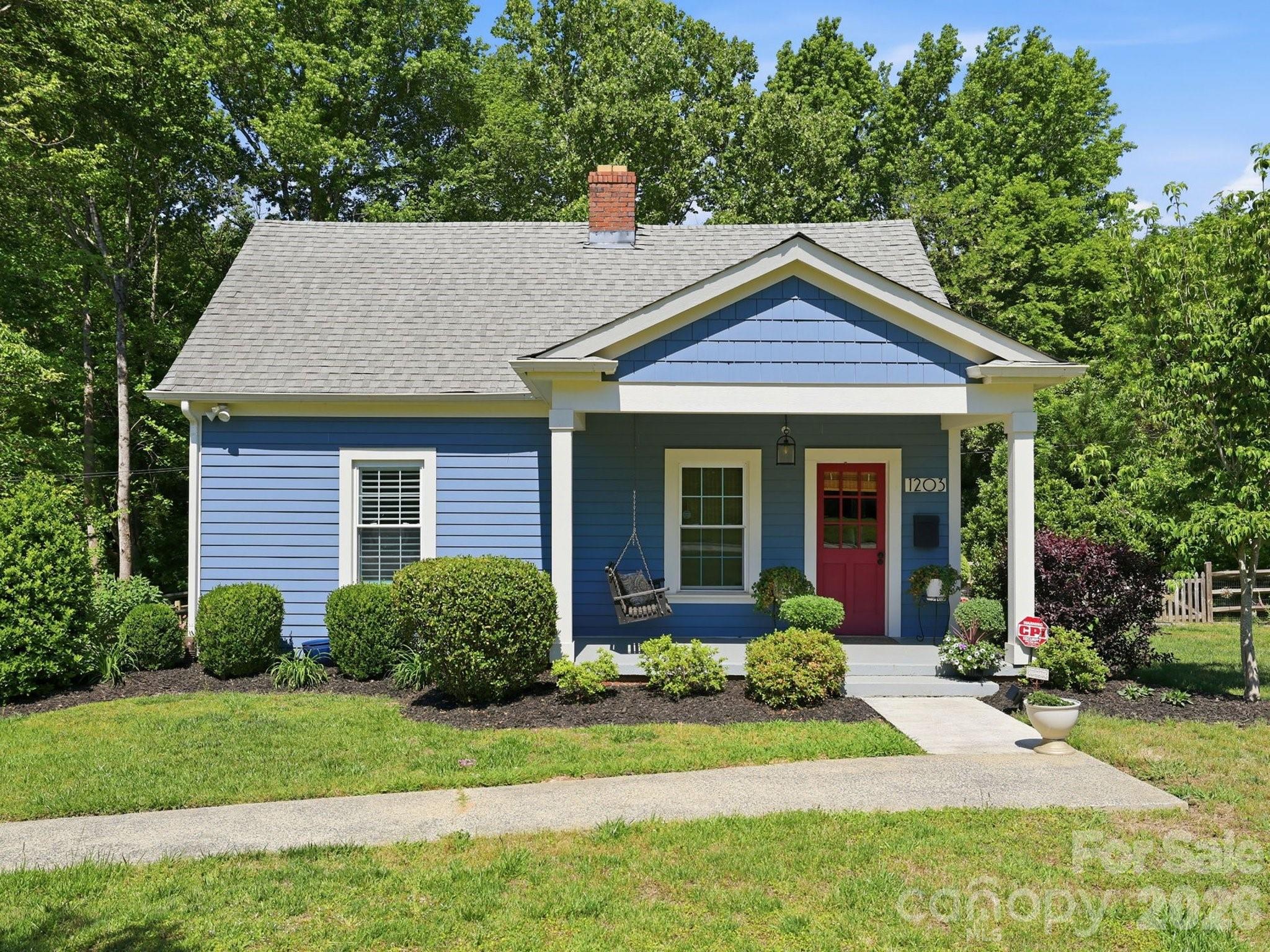 Tucked into the heart of Fort Mill, this charming mill house blends timeless character with thoughtful updates all within the highly sought after Fort Mill School District. The private, fenced backyard is a true standout, backing directly to the Anne Springs Close Greenway, a 2,100-acre natural preserve with 40 miles of trails, lakes for kayaking and fishing, and many beloved spots that bring unmatched access to nature right outside your gate. The yard itself is a peaceful retreat, featuring a vegetable and berry garden, flowering shrubs, mature trees, and swinging chairs perfect for relaxing. Inside, you’ll find beautifully refinished original pine floors, beadboard walls, a fireplace, spacious bedrooms, and new appliances paired with modern finishes that complement the home’s historic charm.  Please ask about the numerous upgrades!