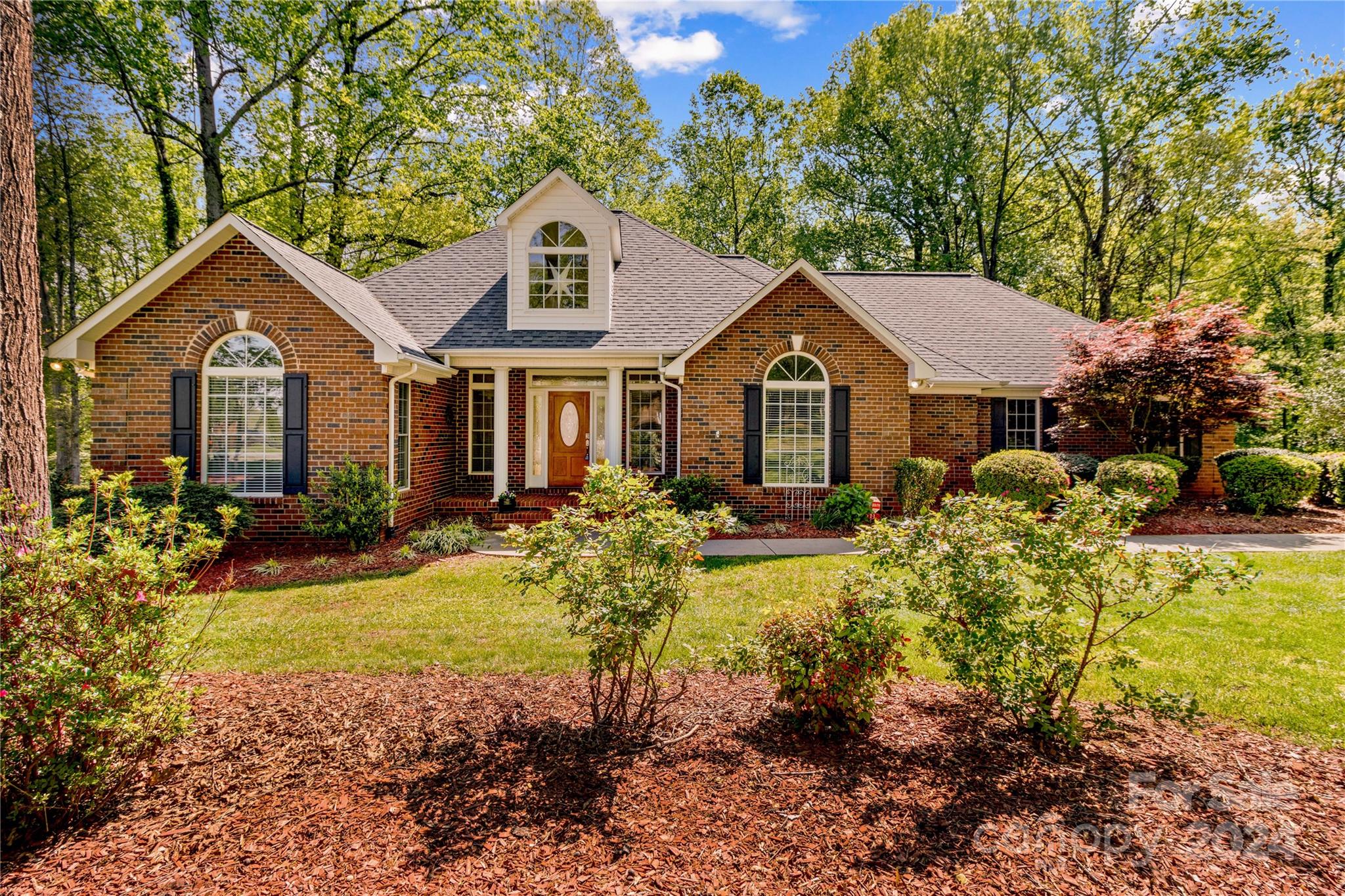 Welcome to your dream home in Baymount Meadows! Light-filled property on 1.17 ac is move-in ready. Enter to find bright living space w/tall ceilings & stunning backyard views through new arched glass double doors. Enjoy morning coffee or evening meals on main floor deck, or relax in newly enclosed screened porch w/ceiling fans. Foyer opens to a cozy living area w/upgraded gas fireplace, adjoining a master bedroom wremodeled en suite& walk-in closet. Hardwood floors enhance the living room, master bedroom, breakfast nook, and kitchen. The remodeled kitchen features a double oven, stainless steel appliances, granite countertops, and a butler’s pantry. The finished basement includes a bonus room (used as a 4th bedroom) w/private bath, a spacious rec area/game room with a bar, and a large unfinished storage room. Easy access to Charlotte and Winston-Salem, low taxes, new HVAC (2016), remodel (2019), and a 50-year roof (2022) add value. Tons of storage and a serene setting await!