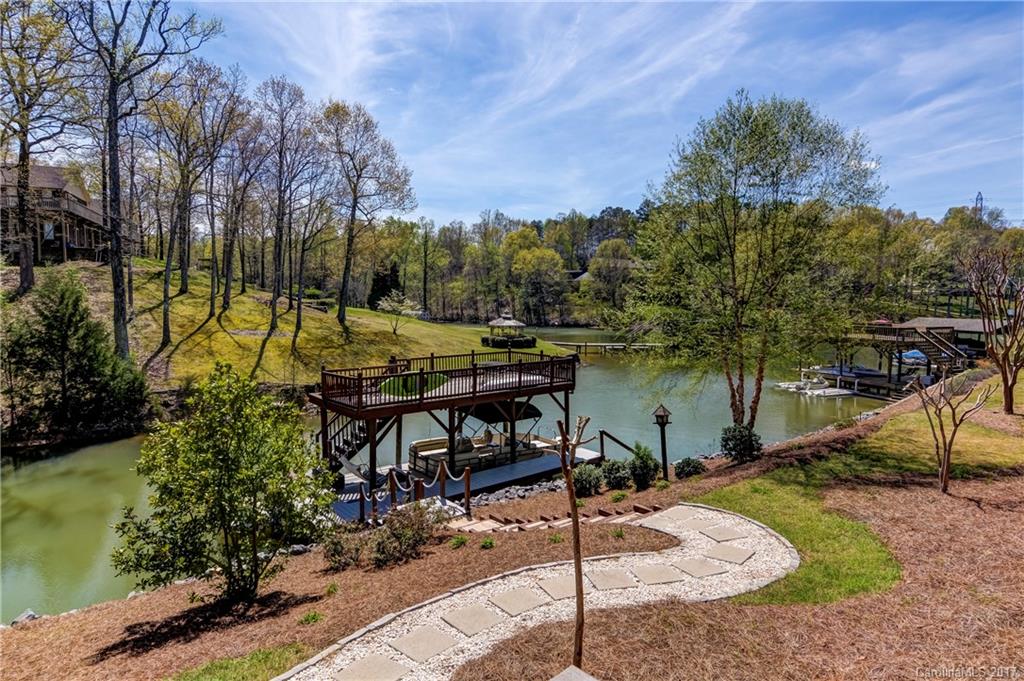 Custom-built waterfront home in sought-after Fort Mill area. Located on quiet cove just off Nivens Creek. Covered dock w/ rooftop deck and lift for boat/jet ski. Gourmet kitchen w/ granite & SS appliances. Great room w/ raised ceilings & wood floors. Spacious master on main w/ luxurious master bath. 2 beds upstairs w/ loft. Lower level w/ 1BR, 1 full bath & large flex room w/ wet bar. Enjoy the outdoors w/ main level screened porch, lower level deck w/ hot tub & beautifully landscaped yard.
