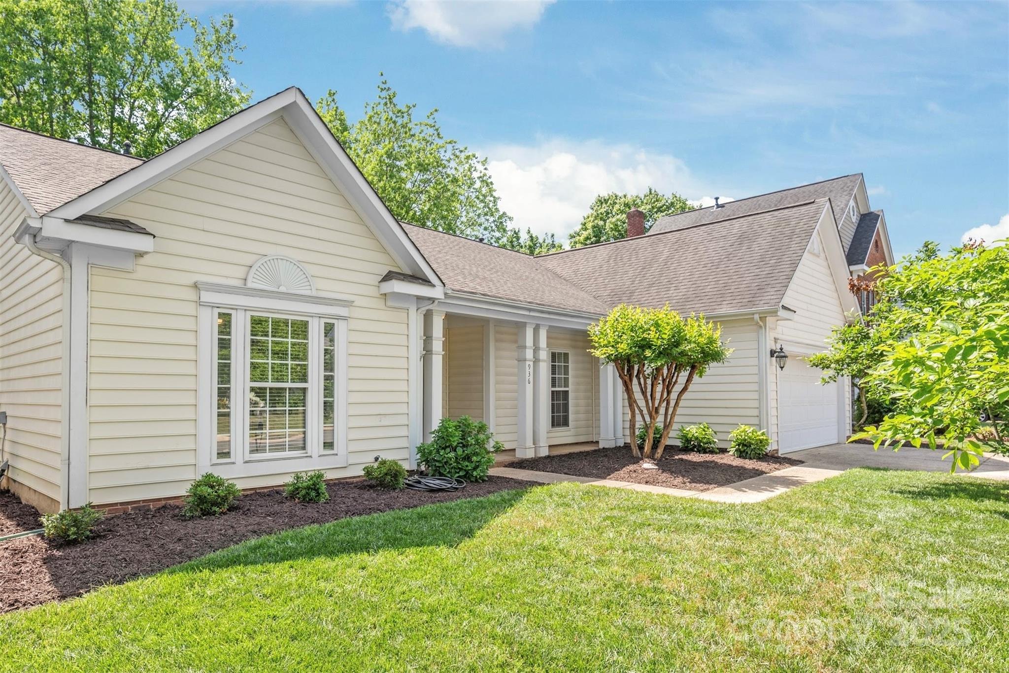 Nestled in one of Fort Mill’s most sought-after neighborhoods and located within the award-winning Fort Mill School District, this charming ranch offers a lifestyle that’s hard to find. From the moment you step onto the welcoming front porch, you’ll feel it: this is a place where memories are made. Inside, you'll find tall ceilings, abundant natural light, and thoughtful custom touches throughout—including luxury vinyl floors, custom trimwork, designer lighting, fixtures, updated door hardware and plumbing (2017) for added peace of mind. The primary suite is a true escape, featuring 2 walk-in closets and a fully renovated ensuite with freestanding soaking tub and frameless shower that feels like your own private spa. Down the hall, the second full bath is just as impressive, with custom finishes and beautiful trimwork. Step outside into your private backyard sanctuary, surrounded by mature trees and a fenced yard—perfect for morning coffee or simply soaking in the peace and quiet.