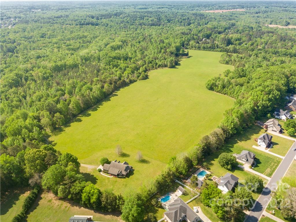 Incredible opportunity to own a gorgeous property +/-48 acres. Nestled between commercial and residential developments in one of the most desirable areas of Rock Hill. Quiet country setting and just a short walk to several restaurants and shopping.  This property is relatively flat with approximately half cleared pasture and half woods bordered by a creek and walnut trees. There is a sewer easement bordering the property, which can be seen on the survey. Located 6.5 miles to I-77 and downtown Rock Hill, and 29 miles to the Charlotte-Douglas Airport.There is a 66 ft wide easement allowing access to the property. This parcel backs up to the land at 470 Forestwood Road for a total of 86+/- acres