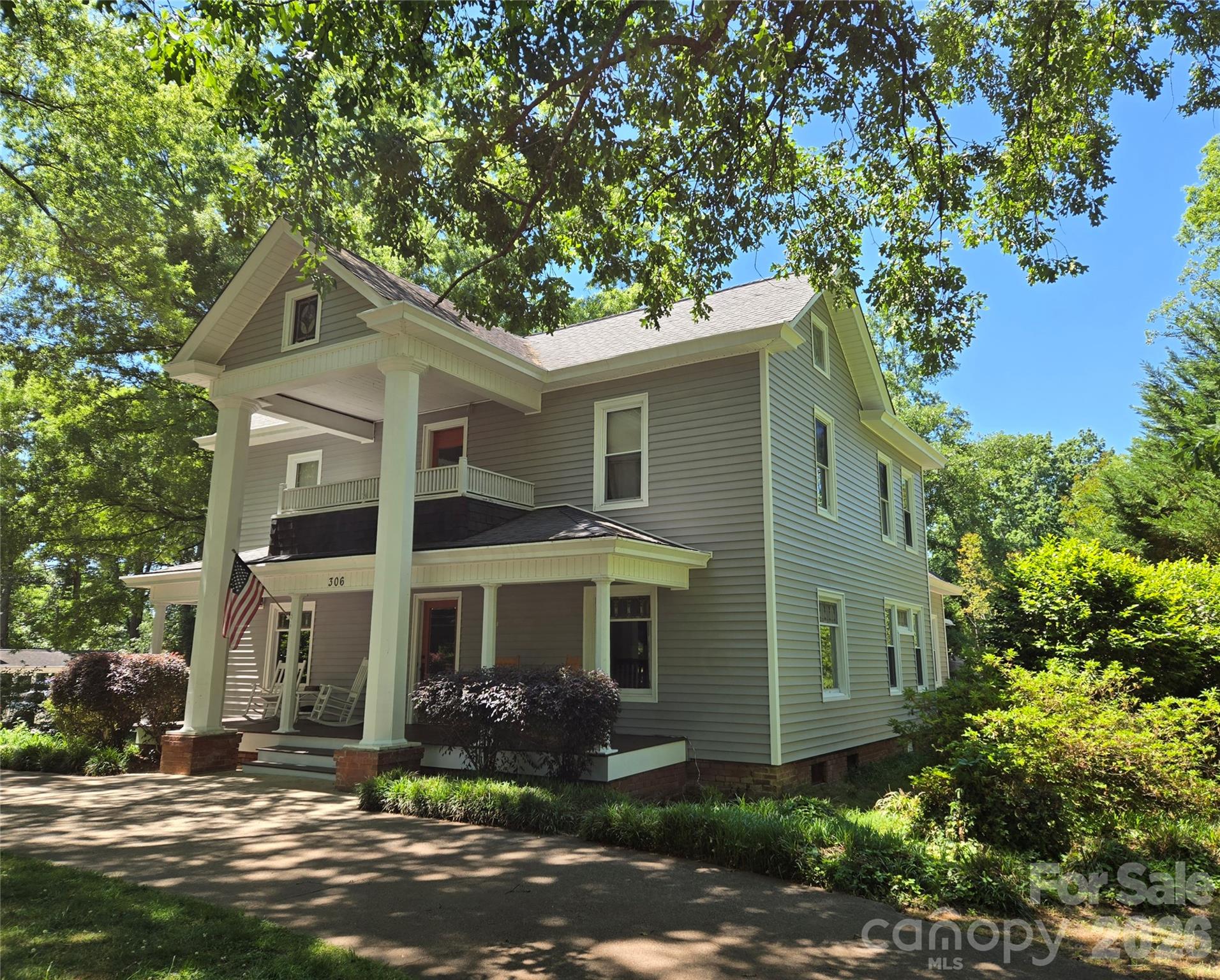 This lovely home embodies the best of early 20th century American architecture; a blend of late Victorian and Craftsman-influenced style boasting of stately classical columns and a wide full front porch. Irreplaceable stained glass adorns front, side and attic windows. The interior features spacious rooms with hardwood floors, high ceilings and wide baseboards. Seller installed Thermador range and dishwasher in 2026 and HVAC in 2023/2024. This home is a rare find - full of history, architectural integrity and character situated on .81 acre of mature trees, lush greenery and flowering bushes. Create your new memories!