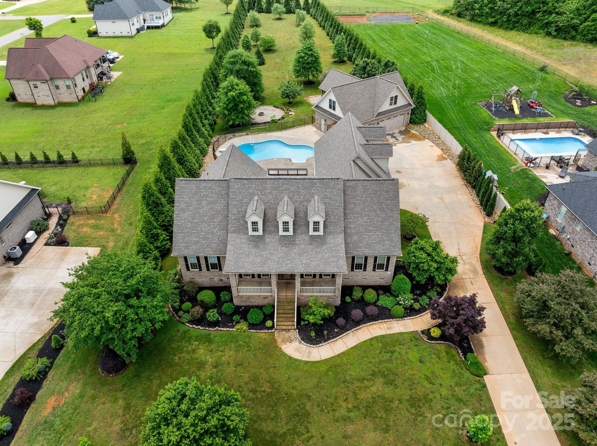 Location, Location, Location.  If you are looking for a home perfectly located between Charlotte and Greenville with easy access to I-85. You have found it!  Extraordinary Home located in one of the most desirable subdivisions in Cherokee County just minutes from Cherokee National Golf & Country Club. This home boast gorgeous recently refinished hardwood floors throughout the main level living areas enhanced by a beautiful rock fireplace, 6 bedrooms, 5 baths, a media room, a sunroom, and a flex room. Outside features a spectacular additional heated and cooled detached 3 car garage and a remarkable yard enclosed by beautiful evergreens to give you ample privacy and exceptional pool and fire pit area.  Recent updates include new roof, new carpet, fresh paint and new bathroom hardware.  The entire detached garage is heated and cooled with 653.30 additional finished sq ft being the flex room & half bath. 
 If sq ft are important, buyers to verify.