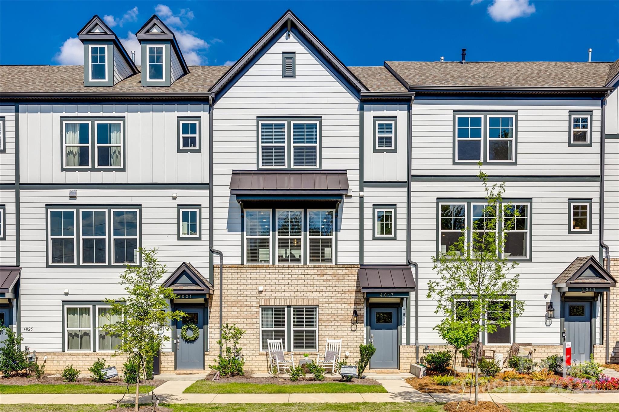 MOTIVATED SELLER! Welcome home to this absolutely stunning townhome in the Hudson Oaks community, conveniently located close to everything Charlotte has to offer. This home offers 4 bedrooms and 3 1/2 bathrooms. The lower level consists of a 2-car garage (220-v outlet, EV compatible), 1 bedroom and a beautiful full bathroom. Upstairs is the main living area with an incredible gourmet kitchen which includes an oversized island, gas cooktop and a deluxe refrigerator! Over in the dining area is an expansive beverage center with even more storage and an additional beverage fridge. Enjoy the gas fireplace on those cooler days or relax on the balcony when the Carolina weather is at its finest. Up the second set of stairs leads to the remaining 3 bedrooms, 2 full bathrooms and laundry. All bedrooms have ceiling fans. The primary bedroom has a custom closet system and the primary bathroom has a stunning full tile shower with bench seat. **Seller offering $5,000 towards buyer's closing costs!**