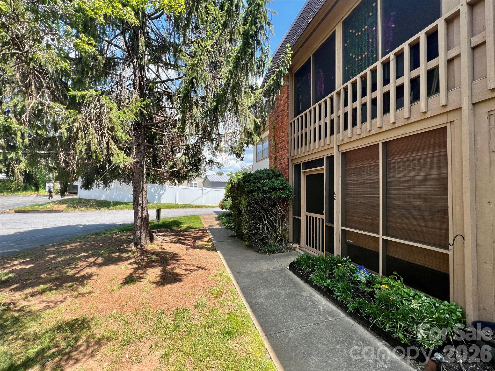 Welcome to Holly Crest — a charming condo community ideally located in downtown Hendersonville. This 2 bedroom, 2 full bathroom main-level unit offers comfortable living with the convenience of city access. Inside, you’ll find a spacious living and dining area featuring updated flooring, abundant natural light, and a functional open layout. The kitchen offers ample cabinetry, generous counter space, and easy flow for everyday living. The primary suite includes a private full bath, while the second bedroom is well-suited for guests, a home office, or flex space. A second full bathroom provides added convenience and privacy. Enjoy relaxing mornings or evenings on the covered porch overlooking mature landscaping. Holly Crest offers a low-maintenance lifestyle just minutes from Hendersonville’s vibrant Main Street — home to local dining, shopping, entertainment, and seasonal events. Whether you're seeking a primary residence, lock-and-leave convenience, or investment opportunity, this downtown condo delivers location, simplicity, and value.