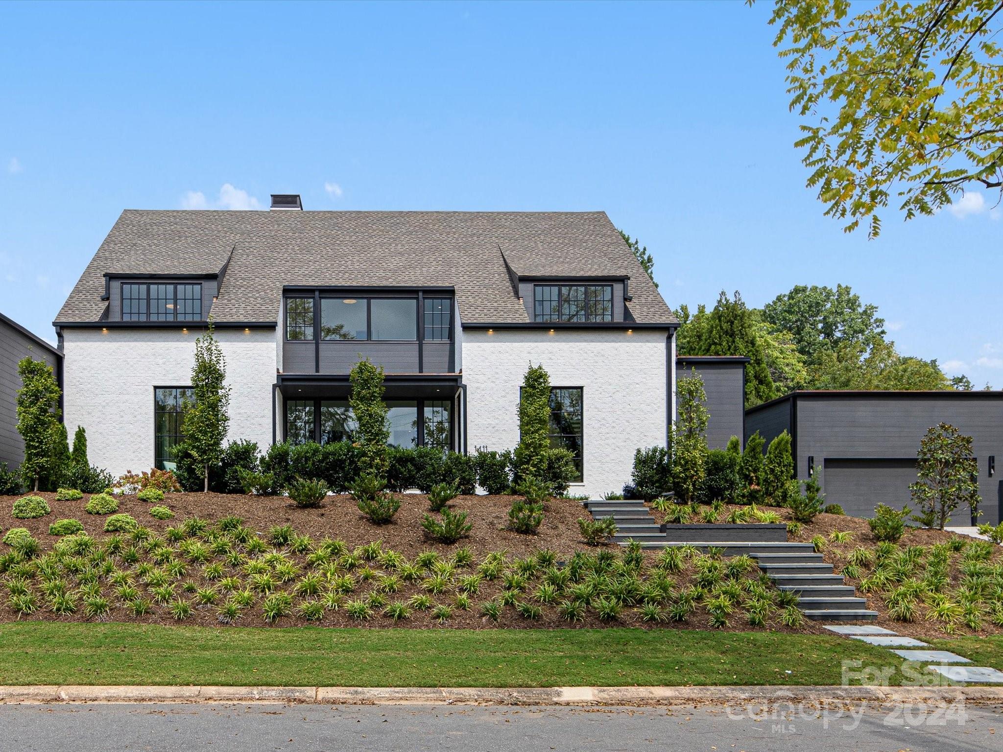 Located on the corner of Willow Oak and Townes in Myers Park are two homes designed by Greg Perry and built by Jas-Am showcasing modern architecture with clean lines and contemporary open spaces. 1411 Townes features a fully enclosed private rear yard, with its own salt water pool, spa and cabana. The Cabana also features a heated and cooled pool bathroom, built in grill/outdoor. kitchen, and heaters.  With over 4100sf and primary suite down, this property lives like a single family home. 3 additional bedrooms upstairs in addition to a large bonus room that could be a 5th bedroom, and a separate office/fitness/flex room.  These homes are built to last with their high end timeless custom finishes and upgraded building materials. See attached features sheet for more information.  ** additional sf is a pool bath (70sf) and garage (624sf), both of which are heated and cooled.