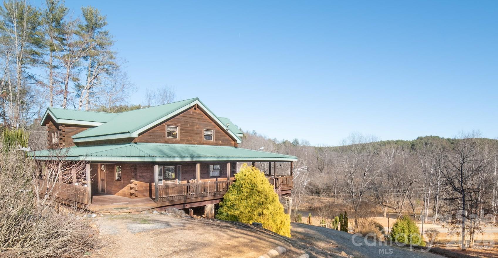 Extraordinary 19.62-acre mountain compound offering breathtaking long-range views, river frontage, and exceptional versatility. The property features approximately 200 feet of frontage along the John’s River, with expansive open spaces ideal for picnicking, camping, and enjoying the natural surroundings. A 3,000+ square foot rustic log home overlooks the river and showcases a generous wrap-around porch, creating the perfect setting for relaxing or entertaining. The home offers three levels of living space, blending timeless mountain character with flexible accommodations for family and guests. The property also includes a large storage garage capable of accommodating an RV or motorhome, along with a private grass runway and substantial hangar building—ideal for aviation enthusiasts or easily repurposed as an impressive workshop or hobby space. From the level runway area, take in stunning, unobstructed views of iconic Table Rock. A tranquil pond further enhances the natural setting. Additional features include fenced areas suitable for horses, a chicken coop for gathering fresh eggs, and ample space for gardens and small-scale homesteading. This remarkable property offers the opportunity to create a private estate by building a custom dream home at the upper elevation to capture sweeping mountain vistas, while utilizing the existing log home as a guest residence or secondary home. With the ability to support multiple residential structures and allowance for vacation rentals, this unique compound presents an exceptional blend of privacy, lifestyle, and long-term potential.