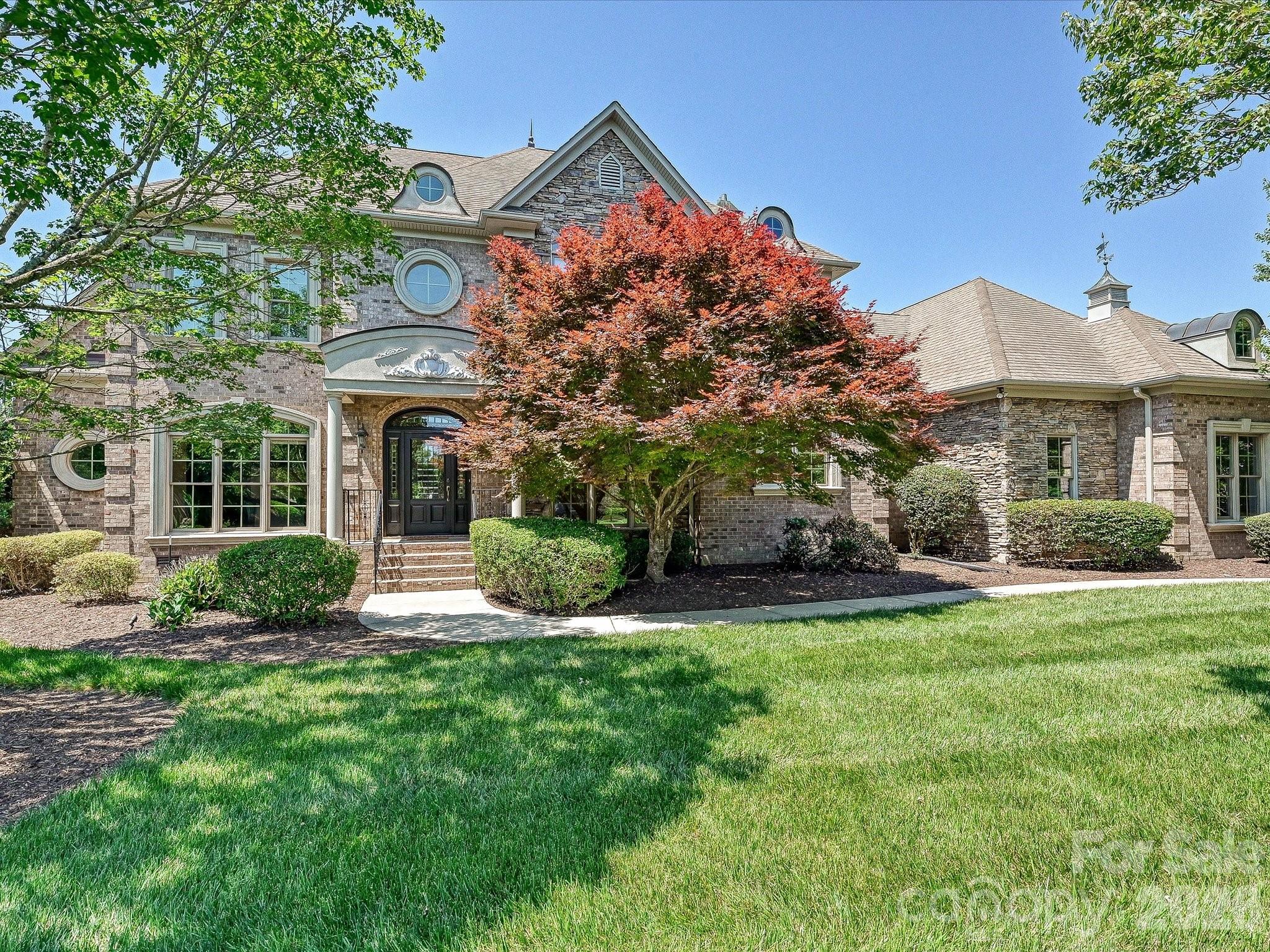 This exquisite 5-bedroom, 3.2-bathroom home, in the sought after gated community of Providence Downs South, with generous amenities & located in a top-rated school district.  Inside, architectural details create a sophisticated atmosphere starting with entrance foyer with it's curved staircase, iron balusters, detailed crown moldings and picture molding and hardwood floors throughout the first floor. Flanking the entrance foyer is a stately office with coffered ceiling and built in shelves and cabinets. On the right is the dining room with wainscoting and triple arched window. The family room has a gas fireplace and is open to the kitchen and dining area and has a wall of glass doors that open on to the terrace and the backyard. The primary suite has a double trey ceiling with recessed lighting, heavy moldings, bumped out sitting area and access to the covered terrace.  The spa-style bathroom has dual walk in closets, dual vanities, jetted tub, stand alone shower and riate water closet. The kitchen has UltraCraft wood cabinets, 2 sinks, 4 burner gas cooktop with wood decorative hood vent. Enjoy relaxing in the all season sunroom off of the dining area and access the terrace and park like fenced backyard that with a large paver patio and built in Fire Magic Gas Grill. Off the hallway across from the kitchen is  large laundry room with cabinets and a sink. This could make a great scullery. Also, don't miss the storage room close to the garage that has endless possibilities - home office, wine cellar.  As you make the way up the back staircase, don't miss the drop zone and the built-in desk. Upstairs there are three spacious bedrooms—one with its own en-suite bath, & two sharing a Jack and Jill bathroom. The front upstairs bedroom has a large walk-in closet and access to attic storage. There is also a bonus room with built-in shelves and a bonus/bedroom with it's own half bath and access more attic storage. A spacious 3-car garage with a storage closet completes this exceptional home. Some highlights - new carpet throughout upstairs and paint in various rooms, HVACs (2019 & 2023), dishwasher (2021), Tankless Water Heater, house generator., leaf guard, Rhino Guard and MYQ garage door opener. This is luxury living redefined in one of the area’s most coveted gated communities. Residents enjoy resort-style amenities including clubhouse, pool, tennis courts, and fitness facilities.
