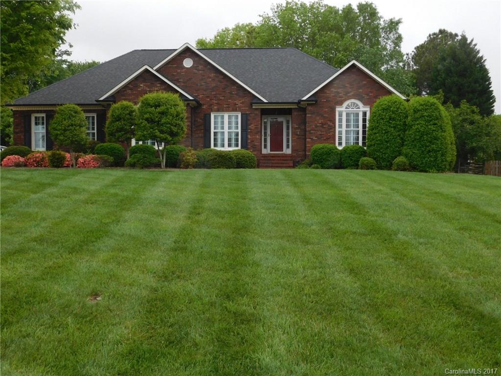 This wonderful brick home, shows like a model. Beautifully landscaped ranch home w/a huge finished garage, fenced backyard & large level lot, covered porch along w/beautiful patio for all your entertaining. Inside enjoy this exquisite kitchen with white cabinets, vaulted ceiling, black countertops & tile backsplash along with SS appliances.  Great room has vaulted ceiling & gas log fireplace.  Feels like country but close to everything including UNCC & I-485.  NO HOA's, well kept neighborhood.