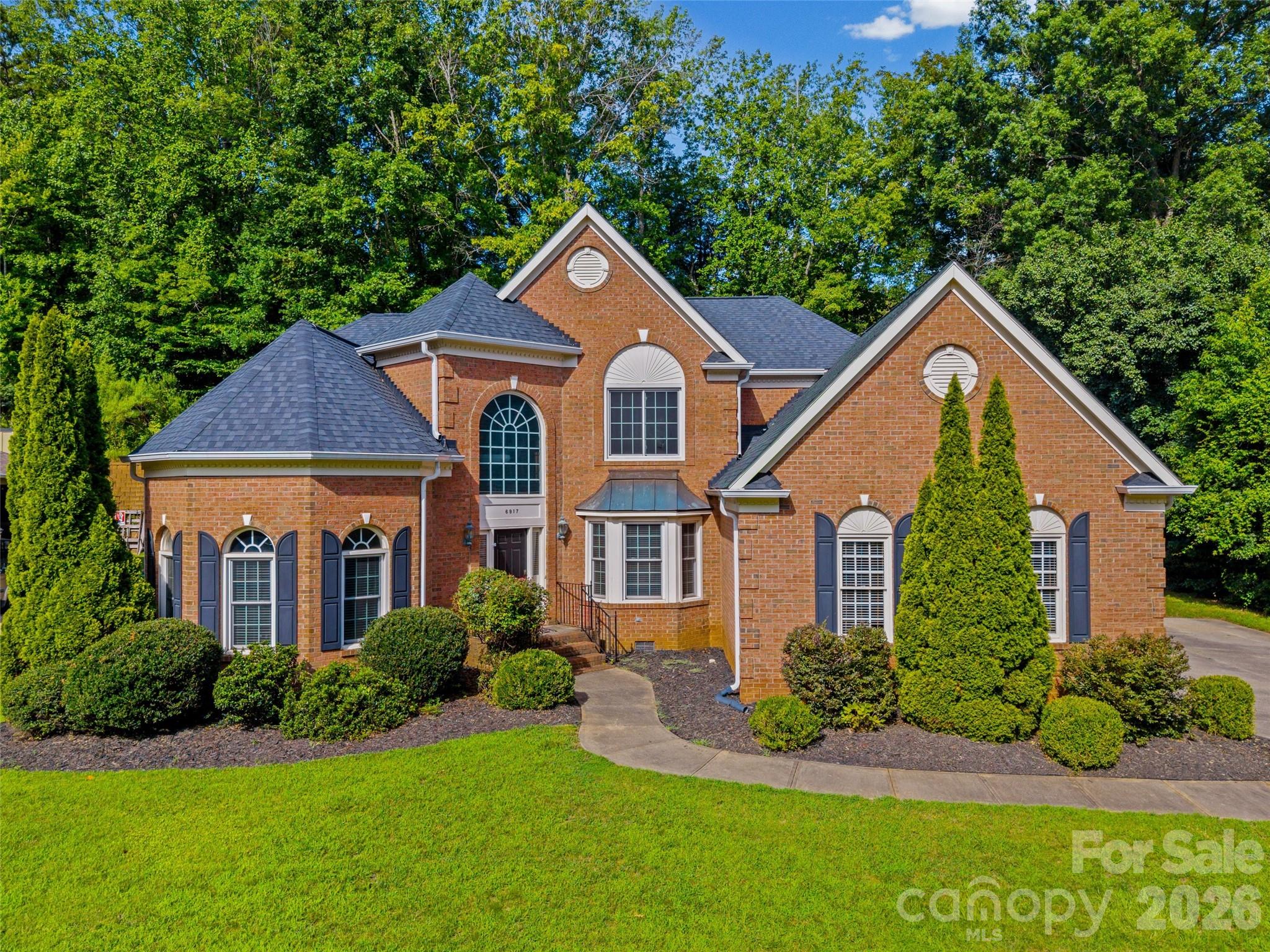 Located in the highly desirable Preserve at Belingrath community, 6917 Riesman Lane is a captivating brick, two-story residence offering 3,012 heated square feet of refined living on a generous 0.35-acre lot. Combining functional everyday comfort with an ideal layout for entertaining, this four-bedroom, two-and-a-half-bath home features an open-concept layout centered around an inviting kitchen that seamlessly flows into the dining area and 2 story living room. The main level provides true convenience with a dedicated home office, a main-floor laundry room, and a luxurious primary suite featuring a newly remodeled primary bathroom. Upstairs, three additional spacious bedrooms offer ample closet space provide accommodation for family or guests. The over-sized 754 square foot attached two-car garage has substantial space for vehicles, EV charger and plenty of storage space. The roof was replaced in 2022 and HVAC units in the 2020's. Enjoy living in an estate-style setting with canopy tree-lined streets with low traffic and wide setbacks . Located in South Charlotte, residents are just minutes from premier shopping and dining in SouthPark, Ballantyne Village, Blakeney, and Stonecrest, as well as the world-renowned Quail Hollow Club. Excellent connectivity to Sharon Road and major thoroughfares makes for an easy 15- to 20-minute commute to Uptown Charlotte or Charlotte Douglas International Airport, combining tranquil neighborhood luxury with unbeatable location.
