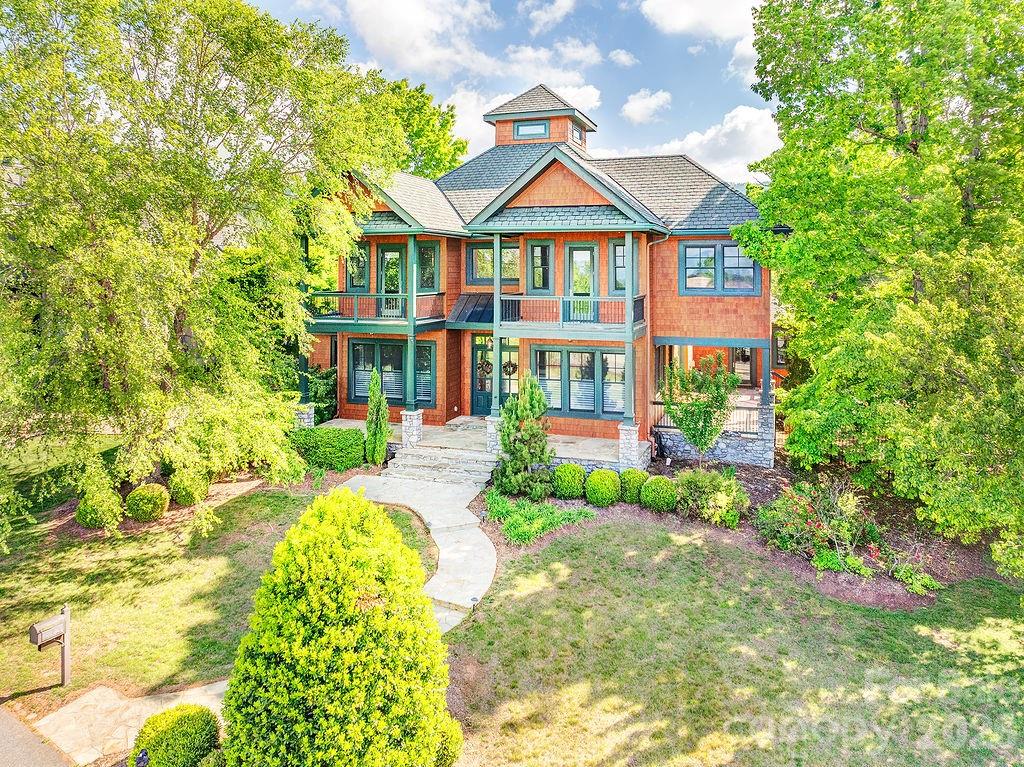 Introducing a residence of exceptional quality, where elegance meets superior craftsmanship. This custom-built home offers 5 bedrooms and 4.5 baths, thoughtfully designed around a highly functional floor plan. The main level features a grand living room and a formal dining room, ideal for both everyday living and entertaining. The gourmet kitchen is a chef’s delight, appointed with premium appliances, dual ovens, a warming drawer, and beautifully crafted custom cabinetry. The primary suite serves as a serene private retreat, complete with a gas fireplace, sitting area, spa-inspired bath with steam shower and whirlpool tub, an expansive walk-in closet, a sunroom, and direct access to the patio. Additional luxury touches include heated floors, remote-controlled blinds, a custom wine cellar, wet bars on both levels, and discreet built-ins—such as a hidden television cabinet in the living room. Enjoy breathtaking mountain views, professionally designed landscaping, a fenced yard, and a spacious 3 car garage with built in storage. Nestled in the picturesque Reems Creek Valley, this home offers the perfect blend of tranquility and convenience—just 5 minutes to downtown Weaverville and 15 minutes to Asheville.
