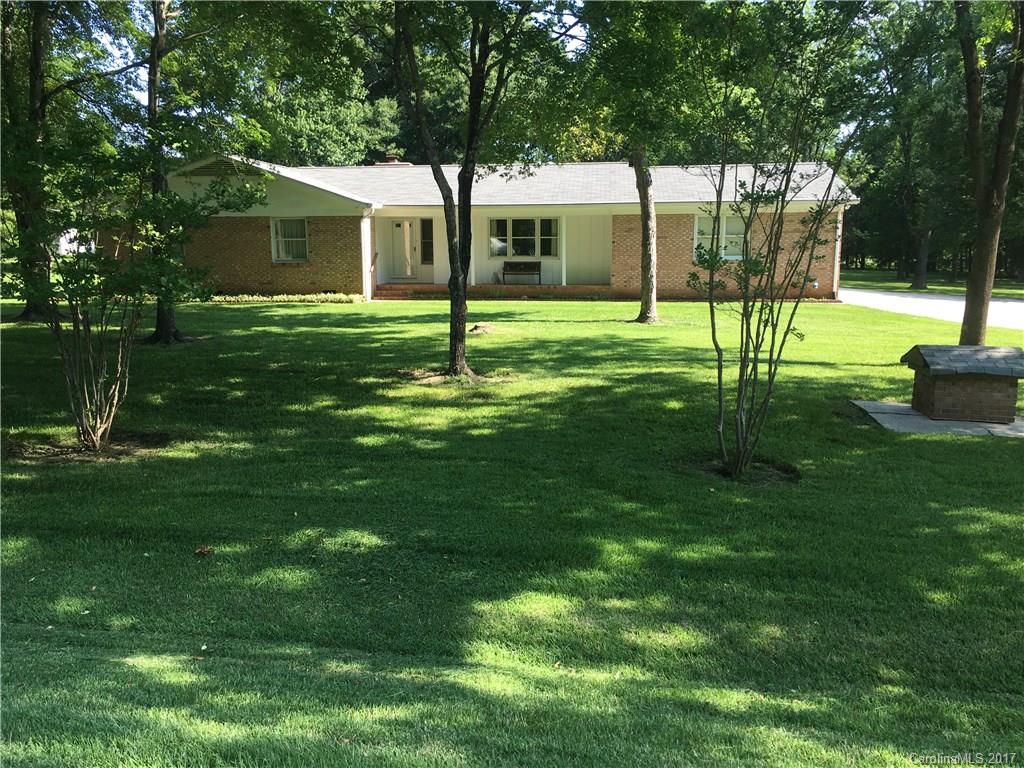 Do some rocking on the front porch or enjoy a very nice sun room with access to a wrap around deck. 1.29 +/-  Acre lot with trees and nice lawn. 2 car garage with work areas. 3 bed rooms 2 baths Den/ fireplace, Kitchen with Range, Refrigerator, nice cabinets .Dining area and living room.Also remaining for the buyer a  front load washer and dryer. Gutter Guardian installed 2008,Roof covering replaced 2008 ,Heat Pump installed 2008. Near Schools, Shopping, Hwy 29,49 & I-85
