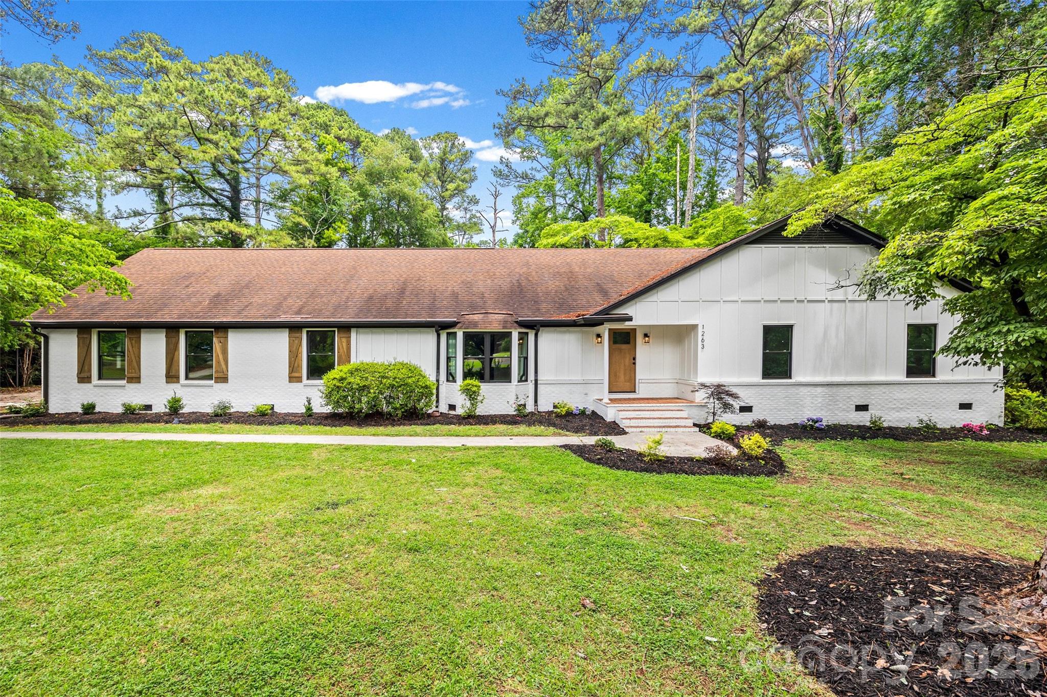 Private estate-style living on 1.28 acres in Rock Hill's highly desirable Meadow Lakes community!

Welcome to 1263 Wendy Road, a beautifully renovated 5-bedroom, 4-bath home offering nearly 3,900 square feet of thoughtfully designed living space surrounded by mature trees, exceptional privacy, and resort-style outdoor living.

Extensively updated while preserving its timeless character, this home offers a level of flexibility rarely found in today's market. With three bedrooms featuring ensuite bathrooms and multiple options for primary suites, the floor plan is ideal for multigenerational living, extended guests, work-from-home lifestyles, or families seeking additional privacy and space.

At the heart of the home, the beautifully updated kitchen opens to spacious gathering areas designed for everyday living and entertaining. The impressive family room provides an incredible central gathering space, while the oversized flex room offers endless possibilities as a billiard room, media room, home gym, office, or playroom.

Step outside and discover what truly sets this property apart. Situated on a private 1.28-acre lot, the backyard feels more like a personal retreat than a traditional neighborhood setting. Mature landscaping, established gardens, stone pathways, and towering trees create a peaceful backdrop for the beautiful in-ground pool and outdoor living spaces. Whether hosting friends, enjoying family gatherings, or simply relaxing after a long day, this backyard was designed to be enjoyed.

Additional highlights include a spacious laundry room, walk-in pantry, detached garage, covered carport, and abundant storage throughout.

Located in one of Rock Hill's most established neighborhoods, Meadow Lakes offers the charm of mature landscaping and larger homesites while remaining convenient to shopping, dining, healthcare, and all the growth occurring throughout the area.

Move-in ready homes offering this combination of acreage, privacy, flexible living space, multiple ensuite bedrooms, and resort-style outdoor amenities rarely become available. Schedule your private tour today.