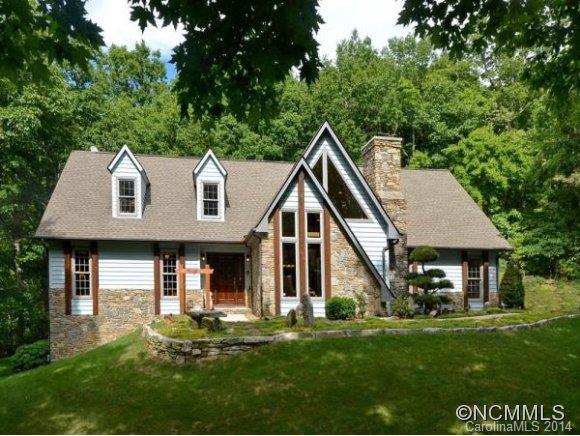 Welcome to your very own mountain top shangri-la! BIG view property w/S/SW views of Mt. Pisgah, Lake Julian and Fairview. Casual comfortable home perched on a grassy bluff circled w/ancient gnarled oaks and sourwood trees. Asian inspired gardens invite you w/flowing rock work, stone patio w/fountain and topiary. Home backs to National Forest for total privacy. This is one of those special spots that gives you the tingles all over!