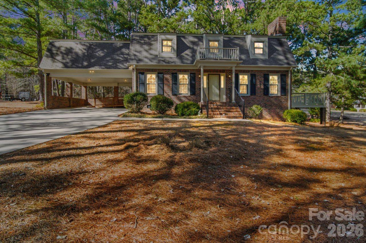 Beautifully maintained 2-story brick home located on a corner lot and in a highly desirable neighborhood. This well-kept property features a primary bedroom and bath on the main level, along with a convenient half bath for guests. The upper level offers two additional bedrooms and a full bath, plus a generous 20x23 attic storage area providing excellent space for seasonal items or future possibilities. Parquet flooring adds warmth and character throughout the foyer, living room, dining room, and primary bedroom. The dining room is accented with classic chair rail molding, creating an inviting space for gatherings. The living room features a charming brick fireplace, perfect for relaxing evenings. Additional highlights include a double carport for convenient parking, a spacious 14x24 side porch ideal for outdoor enjoyment, and a concrete-floored storage area beneath the home for added functionality. This home reflects true pride of ownership — exceptionally neat, well cared for, and move-in ready.