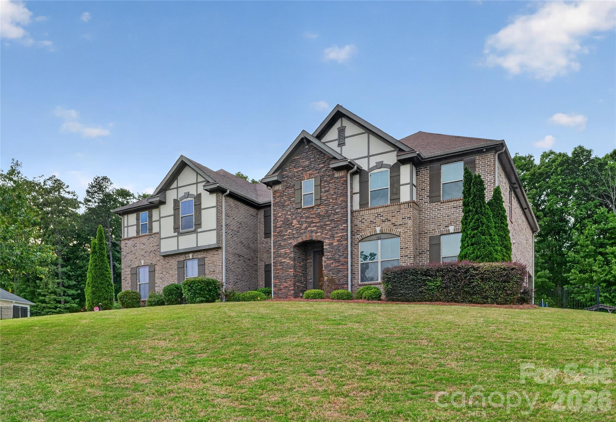 Spacious Living in Gated Devonridge! This property sits on a private 0.93-acre lot in one of Waxhaw's gated communities. This impressive 6-bedroom, 4.5-bath estate offers over 5,000 square feet of elegant living space designed for both everyday comfort and entertaining. The home features spacious gathering areas, flexible living options, and timeless architectural appeal. Enjoy community trails and a scenic pond, all while being minutes from top-rated Weddington schools, shopping, dining, and major commuter routes.

The thoughtfully designed floor plan offers exceptional versatility. The lower level includes a private guest suite with a full bathroom, providing ideal accommodations for extended family, visitors, or multigenerational living. A dedicated office creates the perfect work-from-home space, offering privacy and functionality.

Upstairs, you'll find four generous sized secondary bedrooms along with an impressive primary retreat designed for relaxation. The luxurious primary suite features an upgraded custom walk-in closet with abundant storage and organization. A spacious loft adds additional flexible living space, perfect for a media room, playroom, study area, or second family gathering space.

The combination of a flexible floor plan, desirable community amenities, and prime Waxhaw location, this exceptional home offers the space, comfort, and lifestyle today's buyers are seeking.