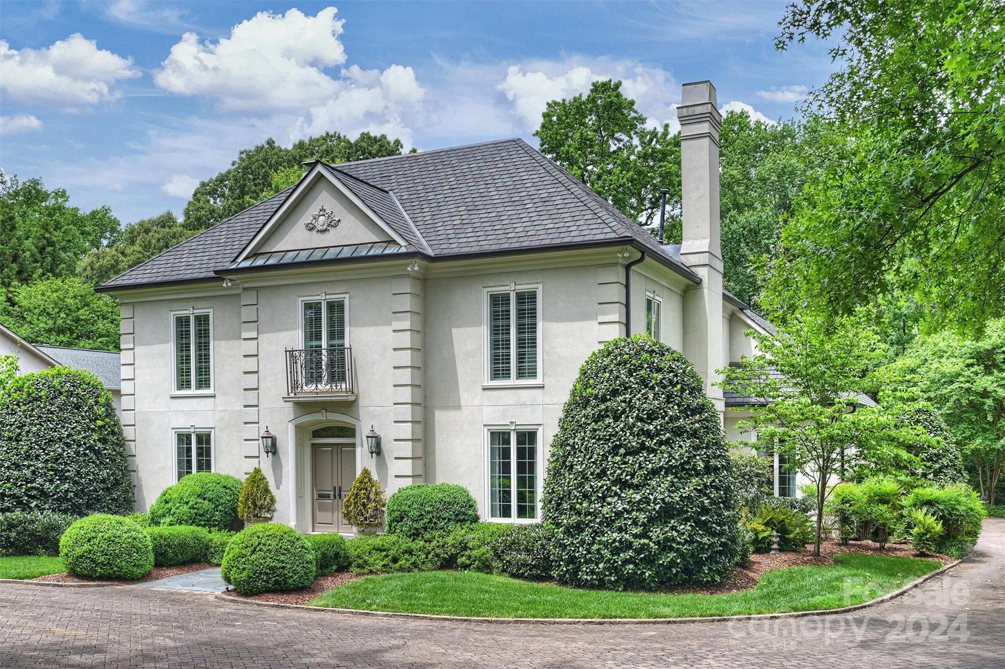 Welcome Home! This neighborhood has no cut through streets and the home sits on a .92 acre lot offering tons of privacy. The ageless layout offers large open rooms with plenty of light coming in through tall windows. The spacious family room with fireplace, and enclosed bar, overlook a large patio and private back yard. Hardwood floors throughout the first floor. The kitchen/ breakfast area also have a door to the patio. Beside the kitchen is a drop zone off the oversized garage. The laundry room contains everything you need with ample storage too. The primary bedroom overlooks the landscaped backyard and includes an en-suite updated bathroom with heated floor. Three additional bedrooms and two full baths on second floor. The wide front staircase goes to a third level that is a floored attic space.. can def develop. There is a bonus room - a must see! Pavers in driveway, copper gutters, ON Demand water system. Close proximity to uptown/ SouthPark/ schools and parks. Make this your own!